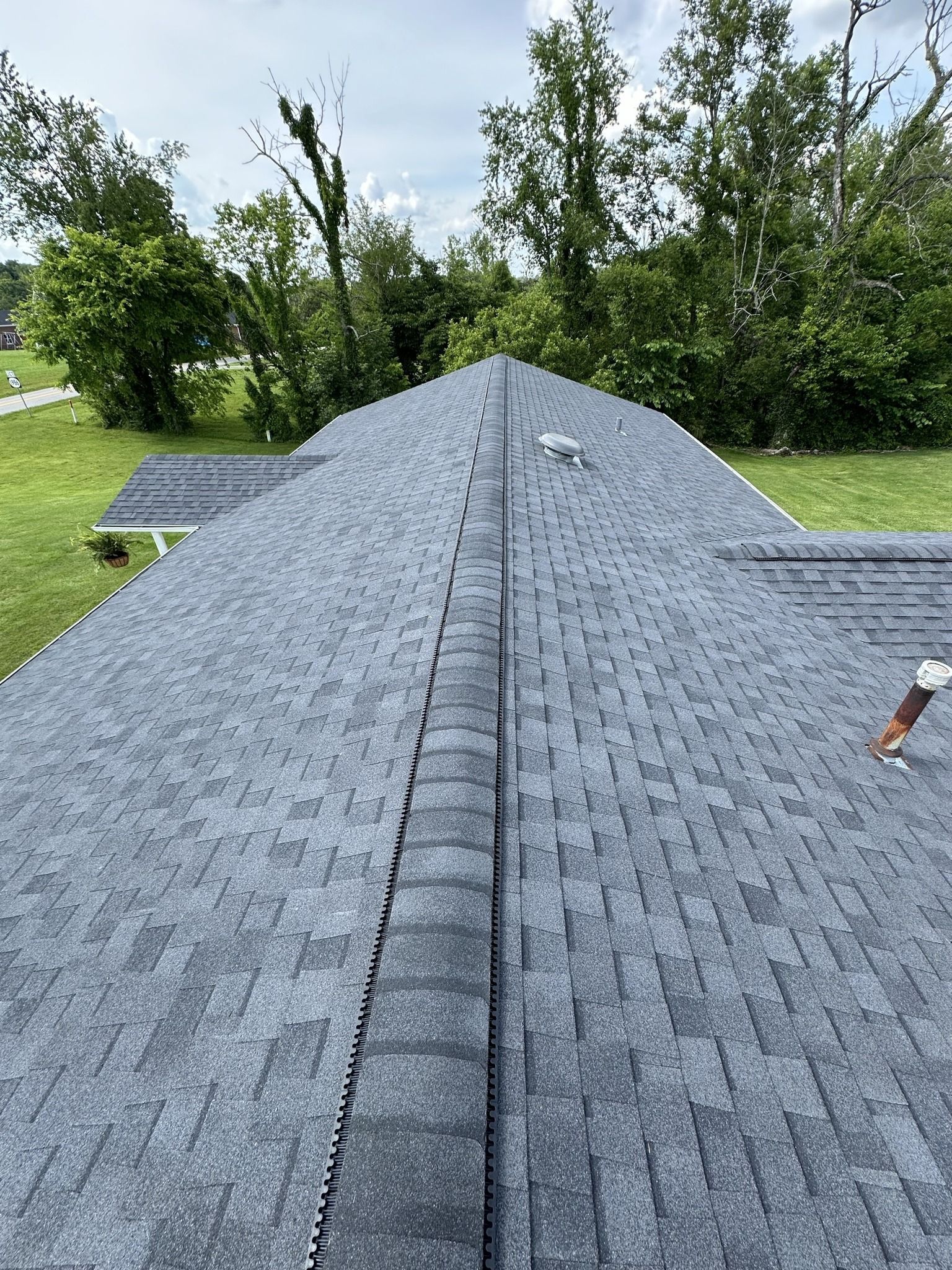 A close up of a roof with a lot of shingles on it.