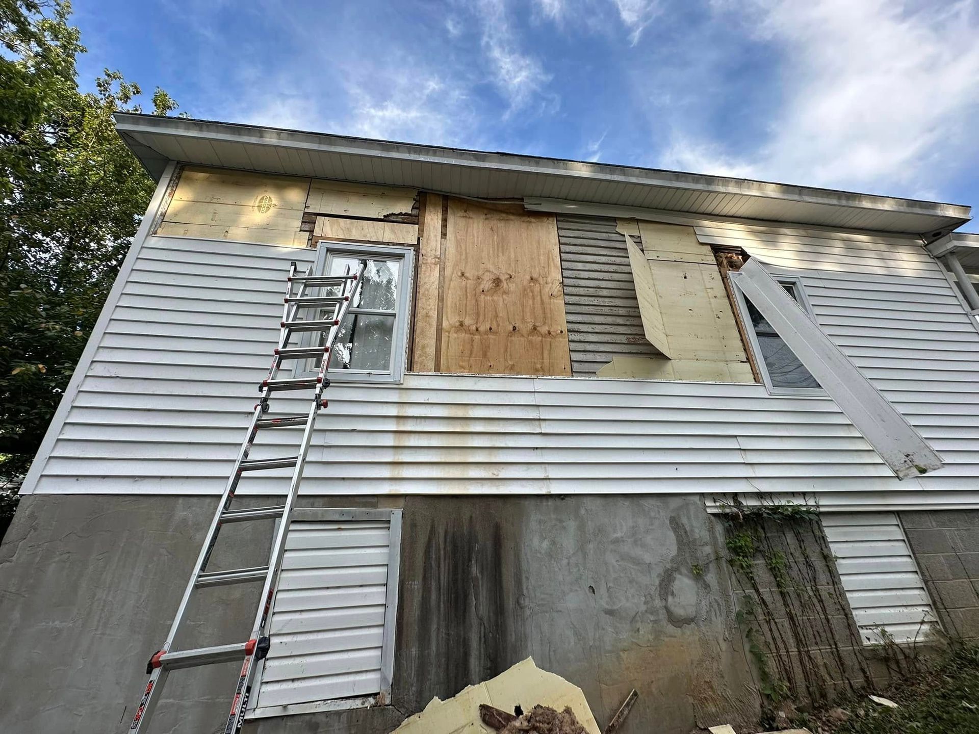 A ladder is sitting on the side of a house.