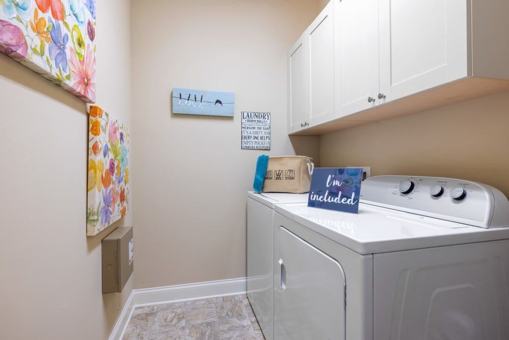 A laundry room with a washer and dryer in it at Marquis Ellis Crossing in Durham, NC.