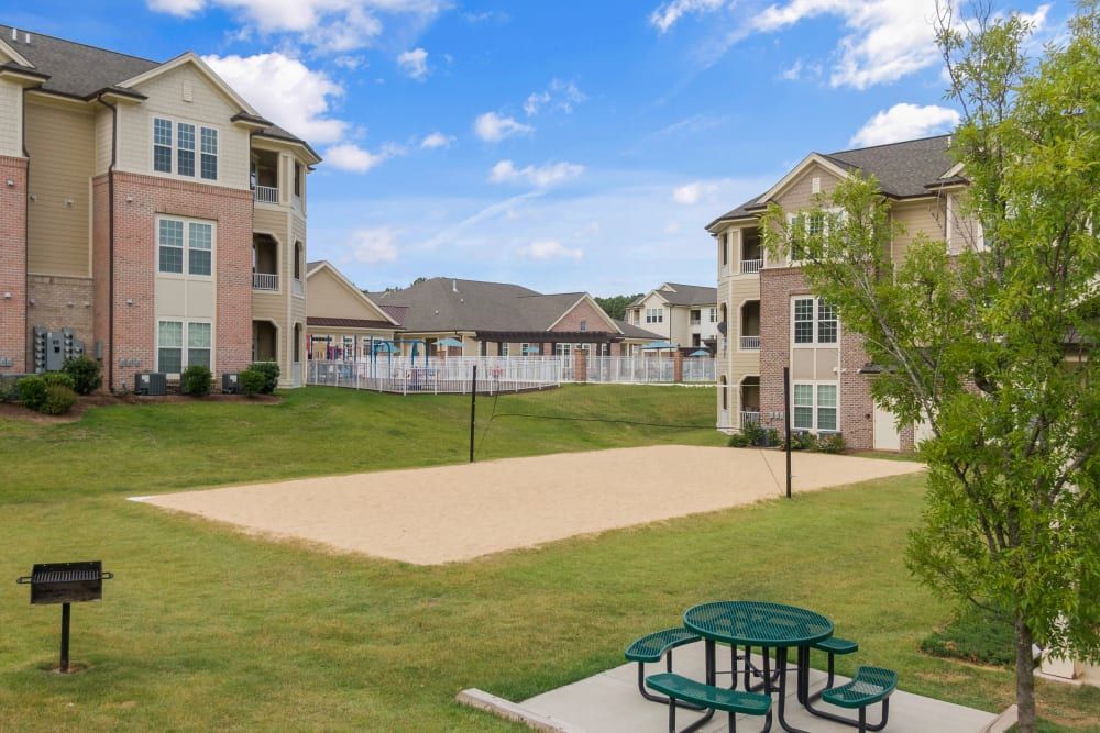 A volleyball court with a picnic table at Marquis Ellis Crossing in Durham, NC.