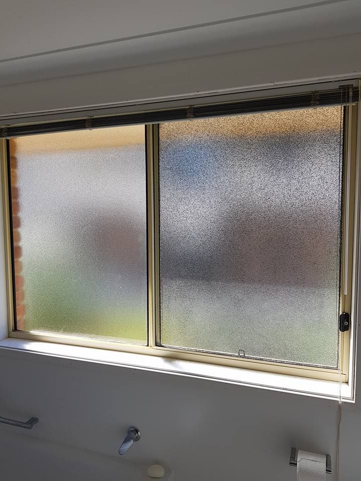A Bathroom Window With a Sliding Glass Door and Blinds — Moss Vale Glass In Moss Vale, NSW