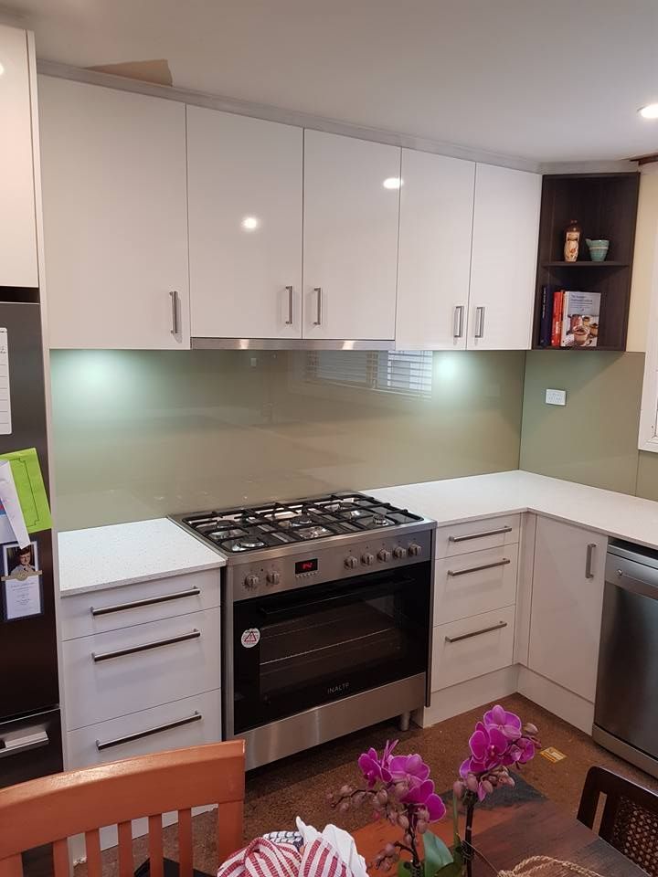 A Kitchen With White Cabinets, a Stove and a Refrigerator — Moss Vale Glass In Bowral, NSW