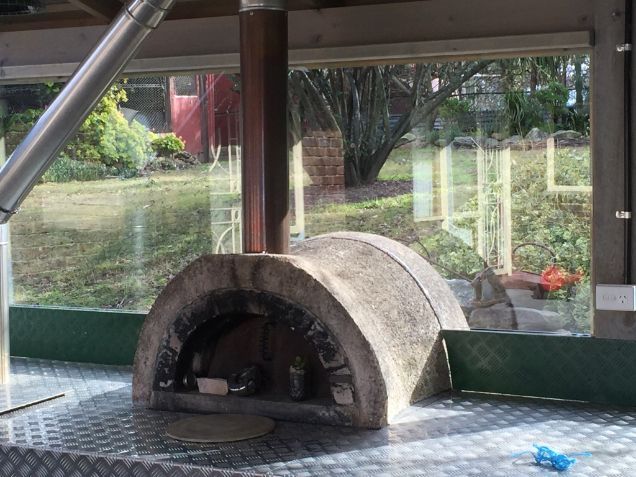 A Large Stone Oven is in a Room With a Large Window — Moss Vale Glass In Bowral, NSW