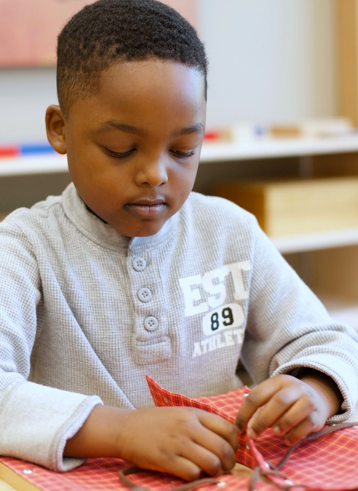 Montessori child working on practical life skills