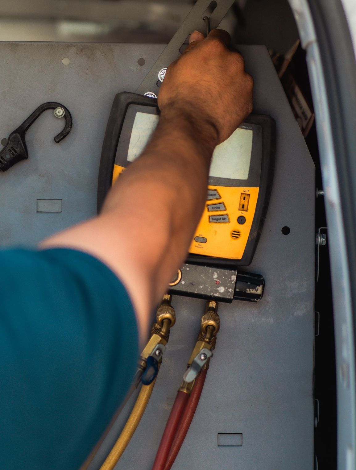A & G Technician is using a digital thermometer in a van in San Bernardino County.