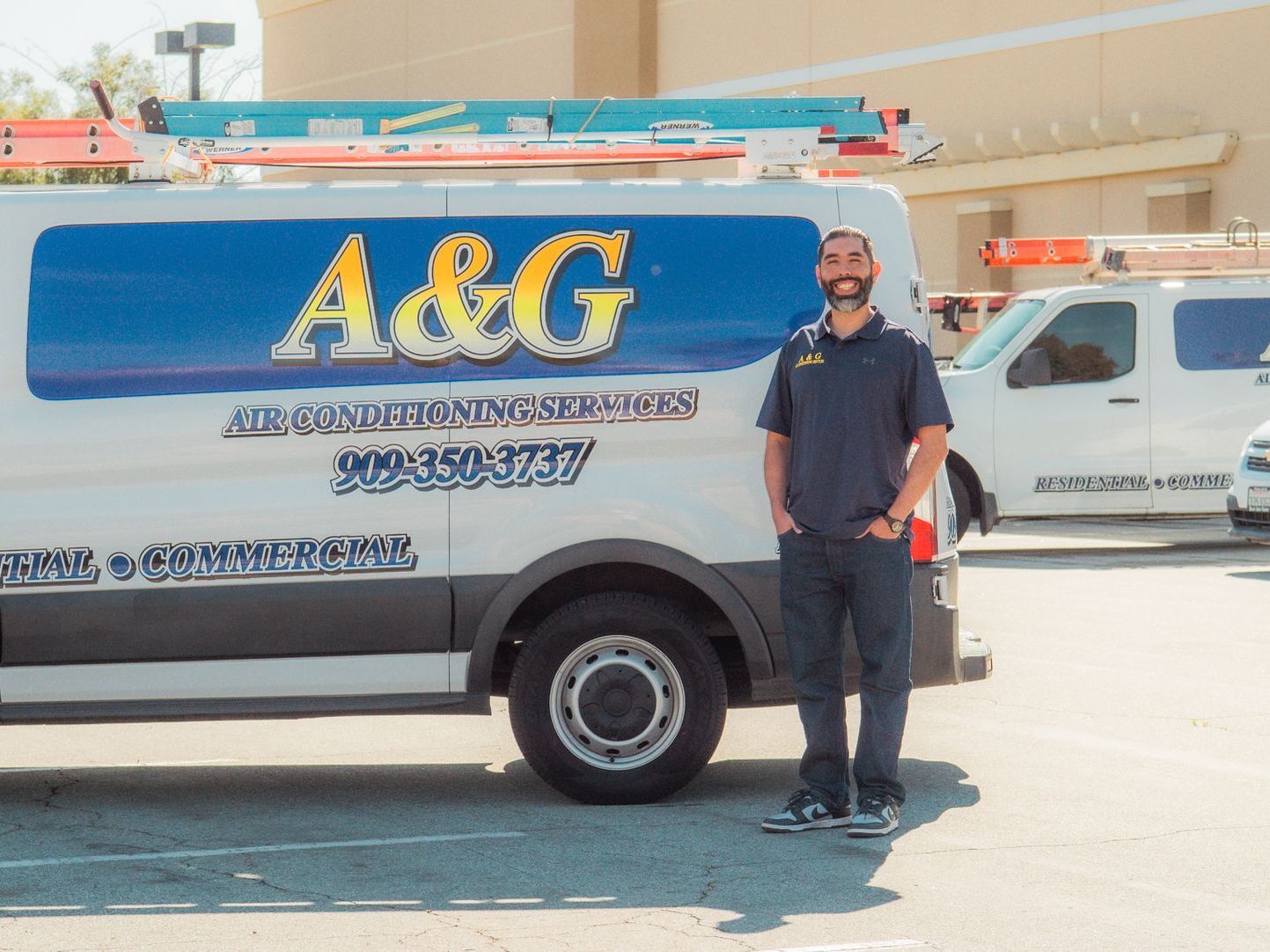 A&G Air Solutions Technician is standing in front of work truck. Adrian
