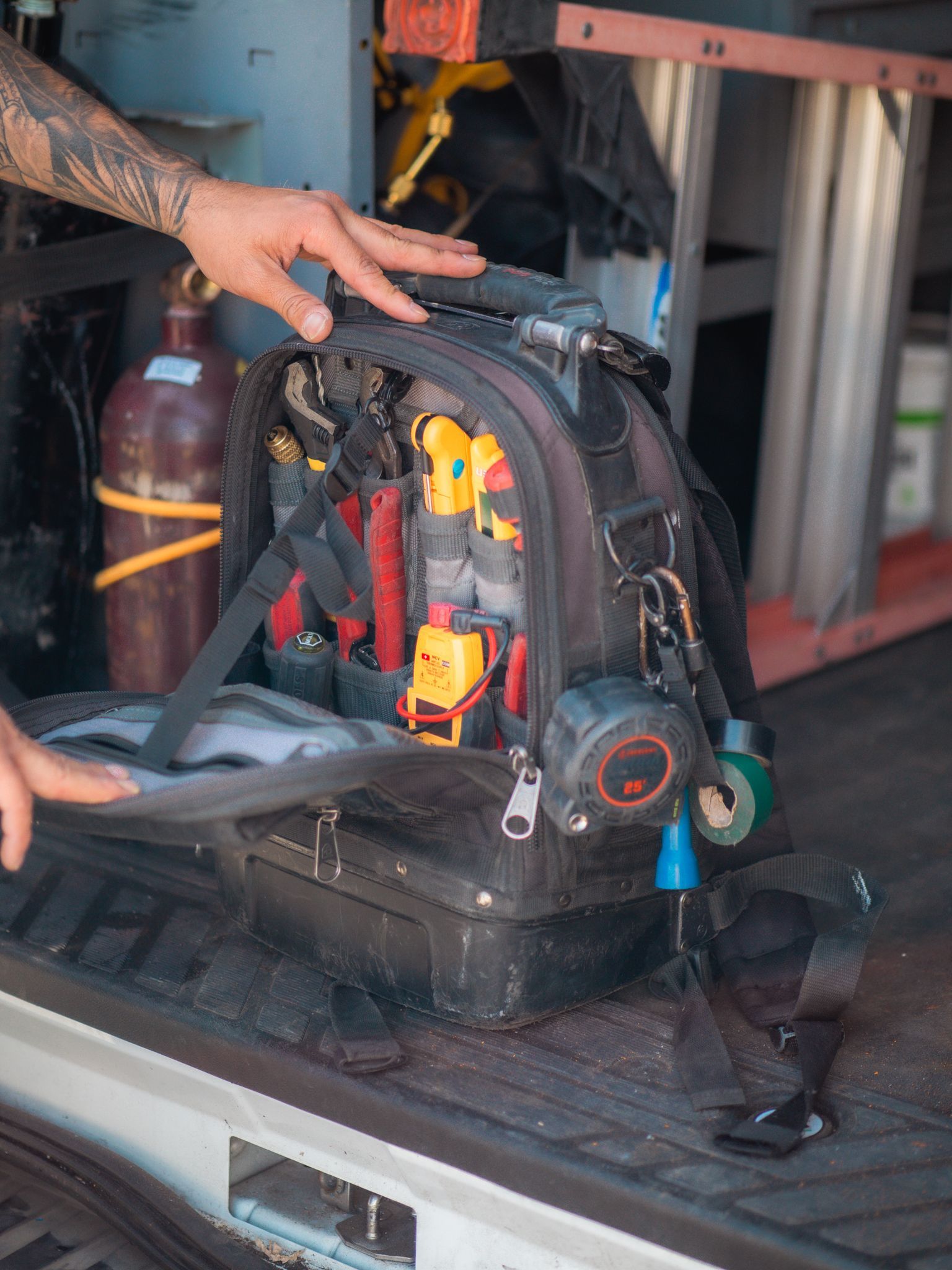 A & G Technician is opening a tool bag in a van.