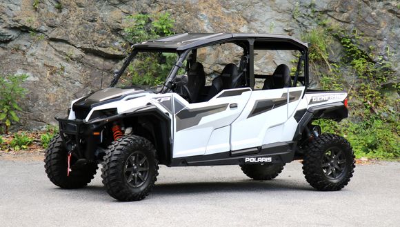 A black utility vehicle is parked on the side of the road.