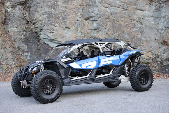 A black utility vehicle is parked on the side of the road.
