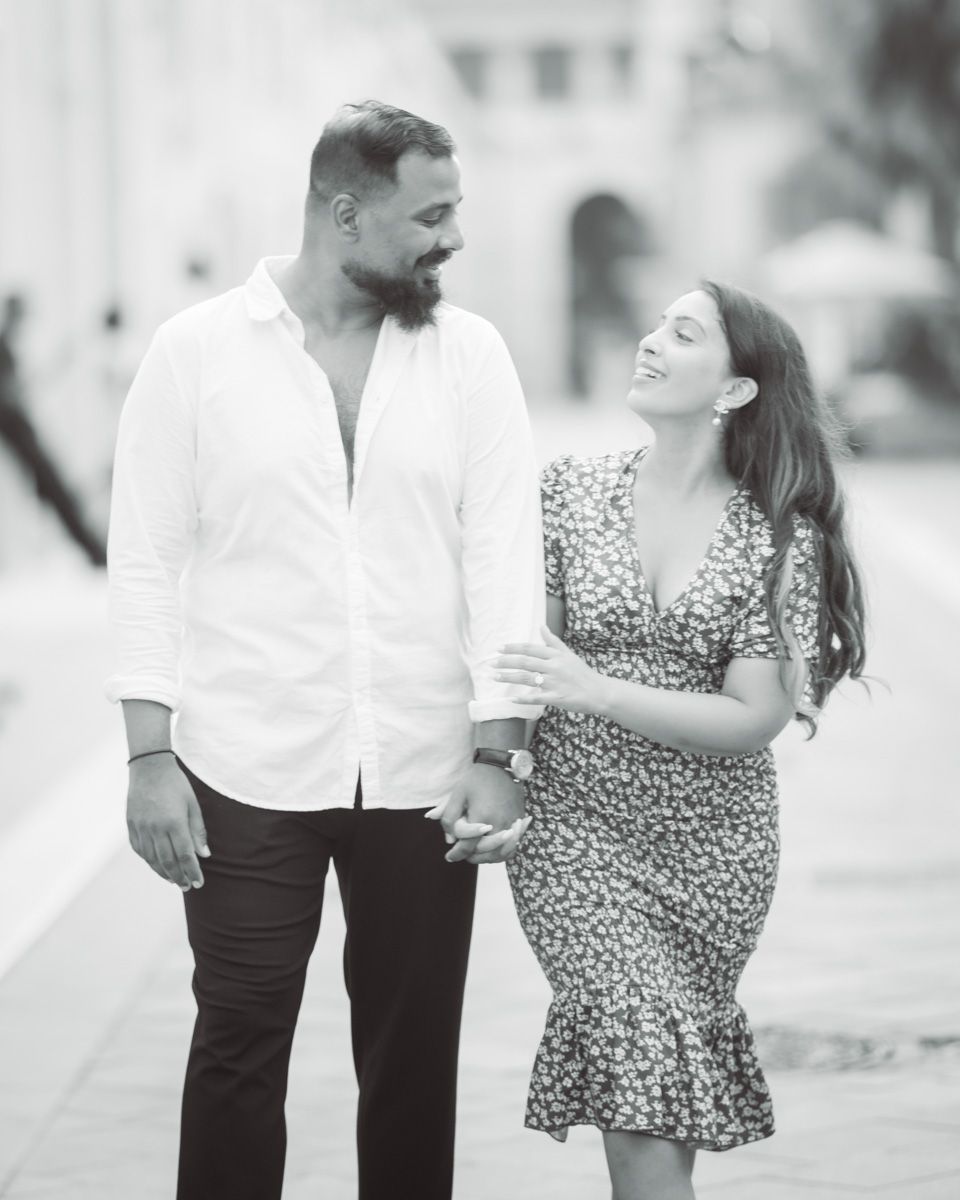 A happy couple walk and talk during a romantic photoshoot in Nice, France
