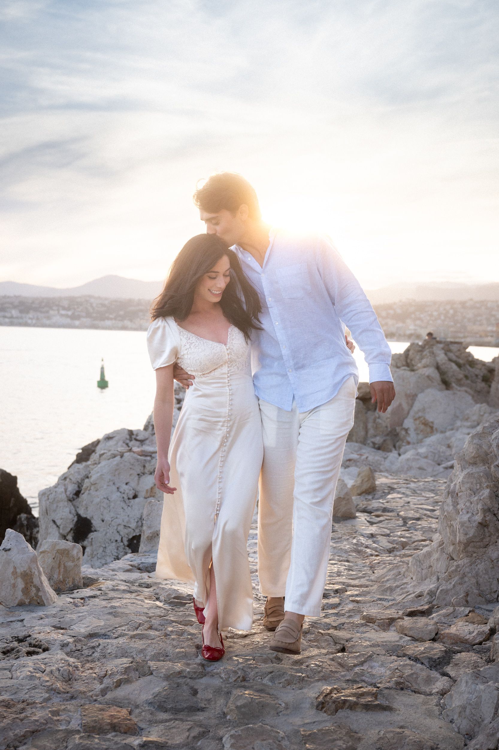 A couple during an elopement photoshoot on a coastal path at sunset on the French Riviera.