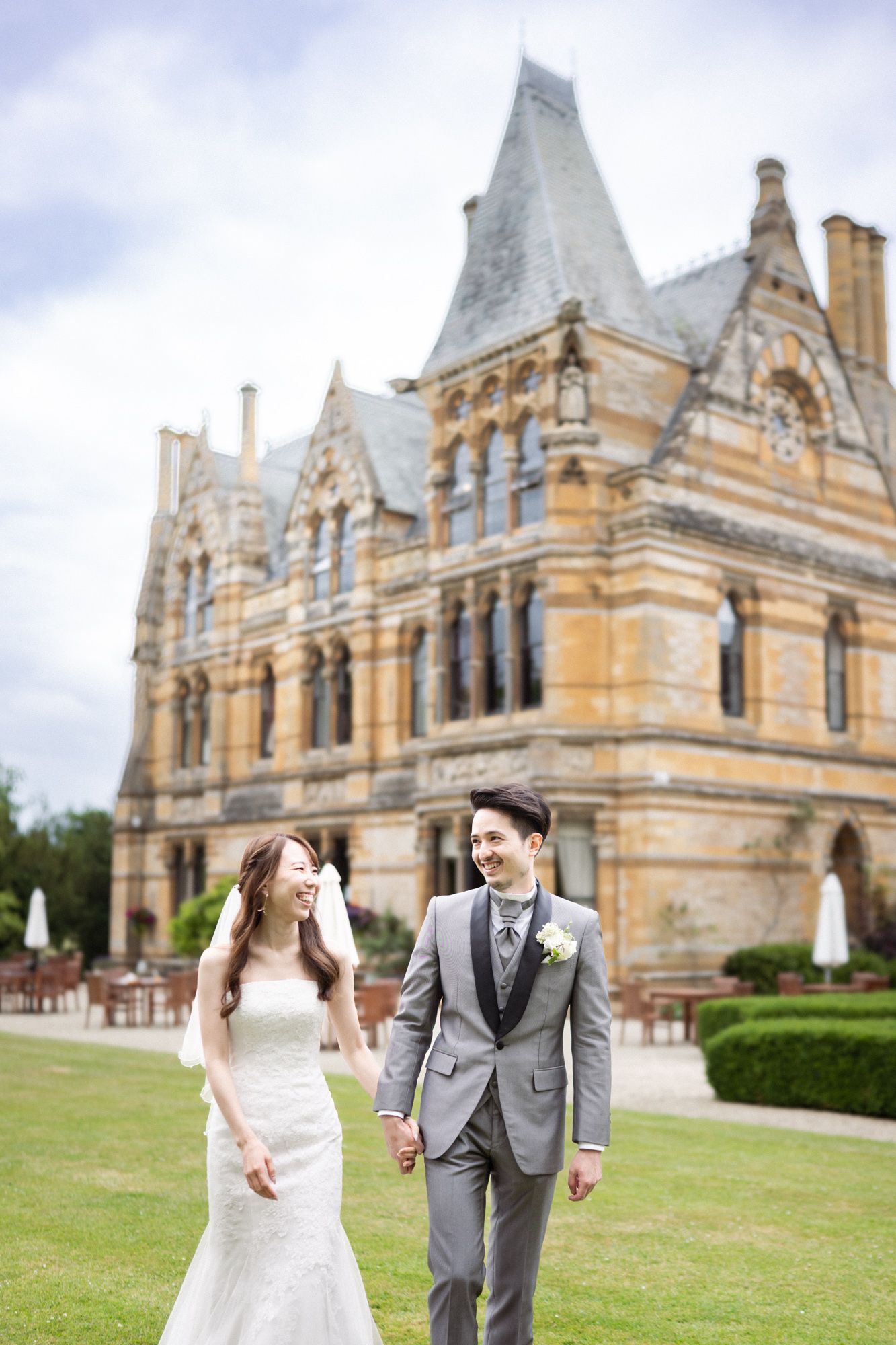 Newly weds laugh and smile during a relaxed, natural photoshoot at Ettington Park