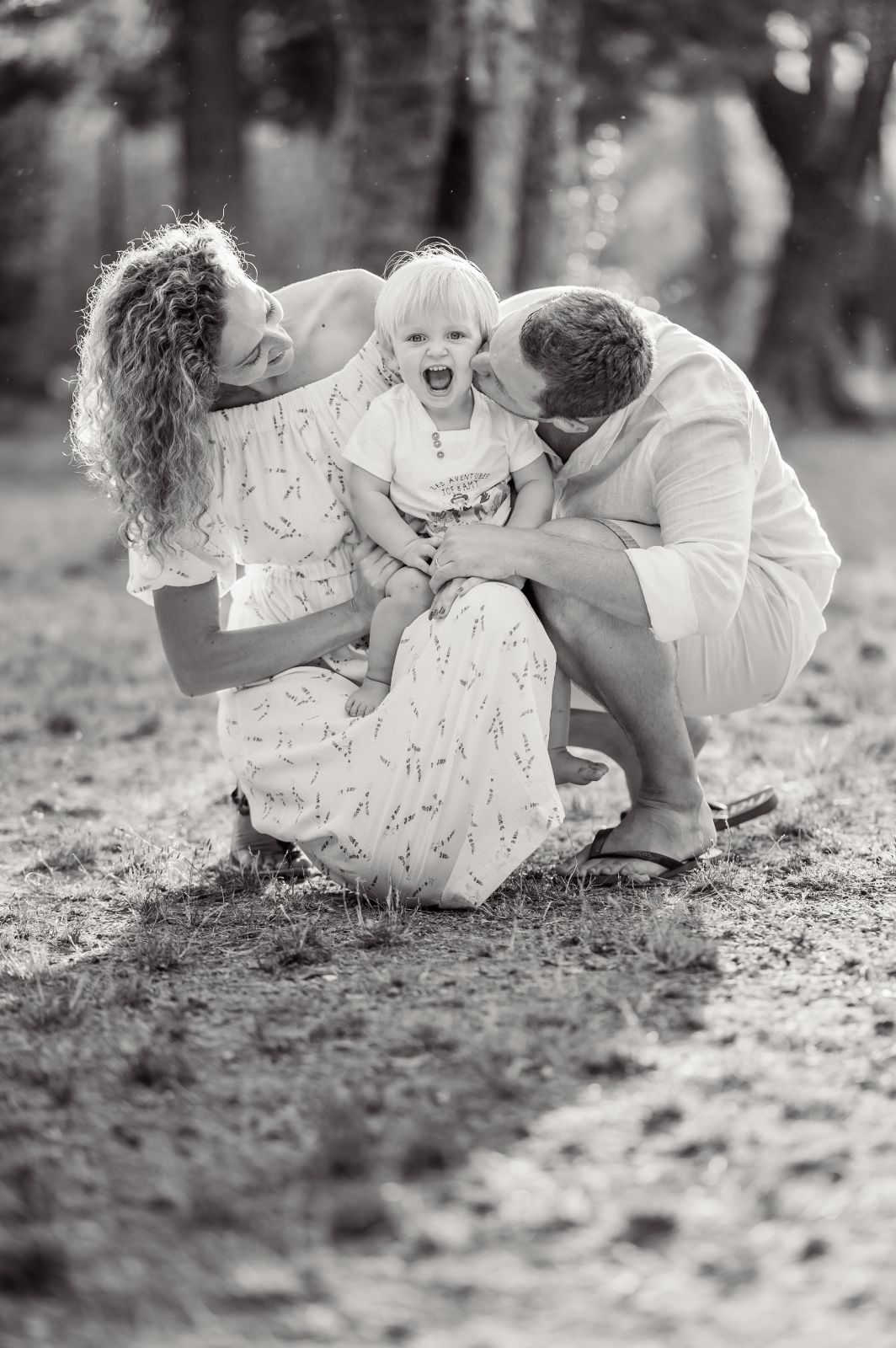 mum and dad kissing son