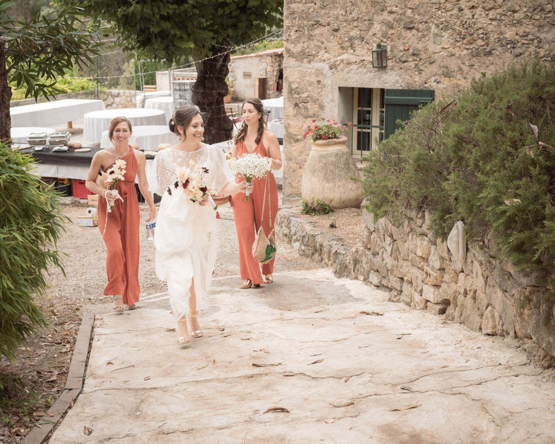 bride walking through cobbled pathway to wedding venue
