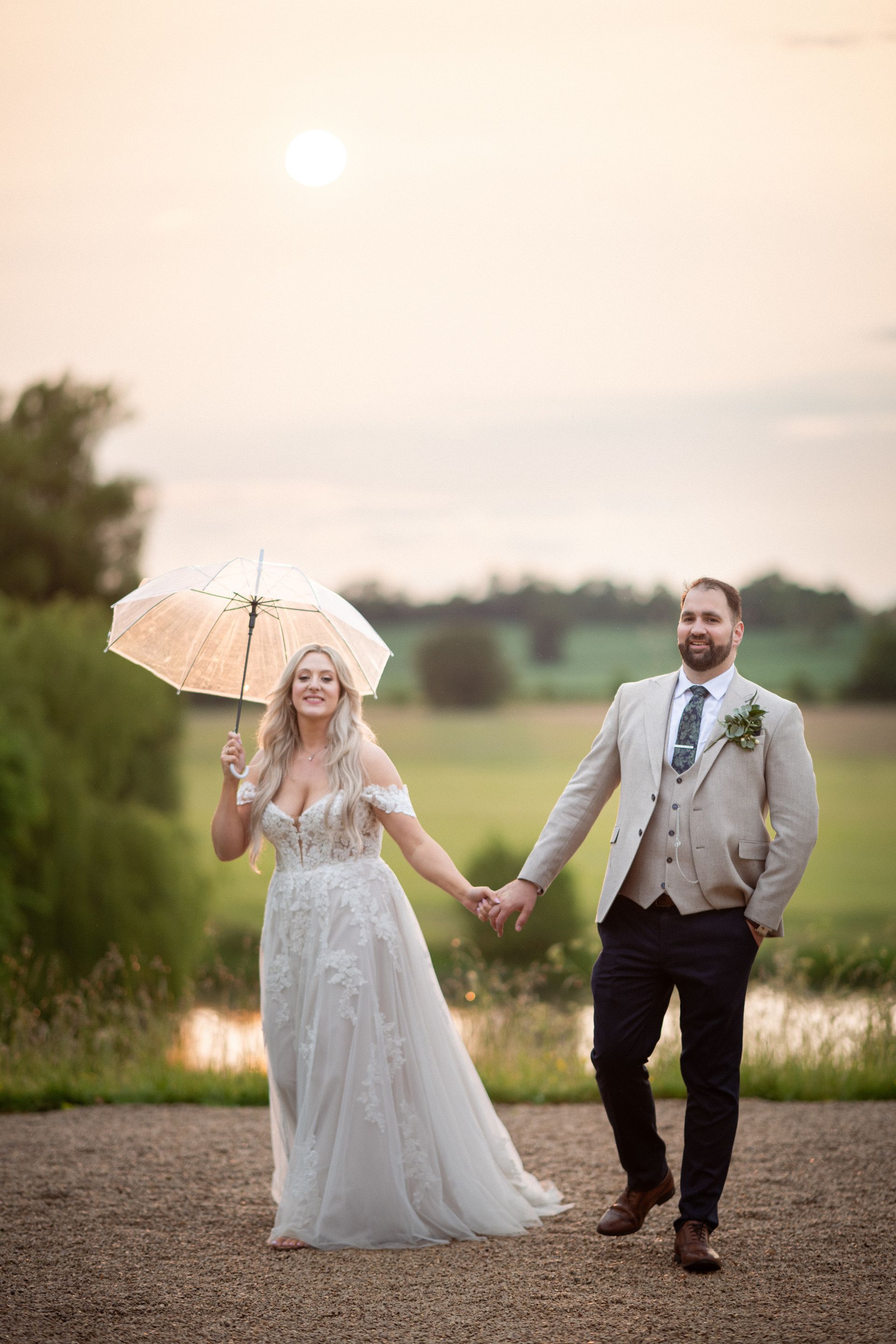 Newly weds have some portrait photos taken in the grounds of Kelmarsh Hall.