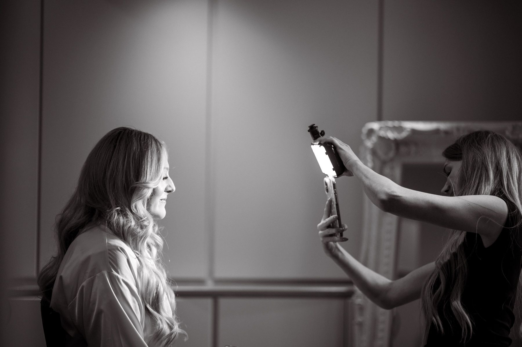The bride's make up artist photographing the bride.