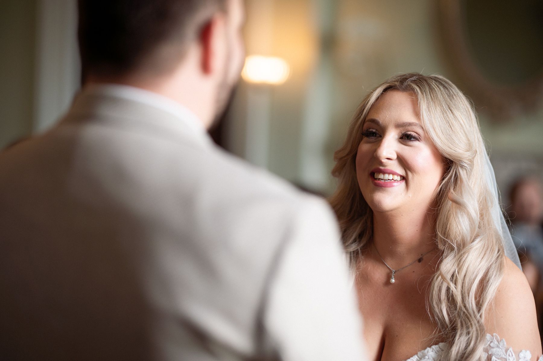 A couple exchange vows during their indoor wedding ceremony.