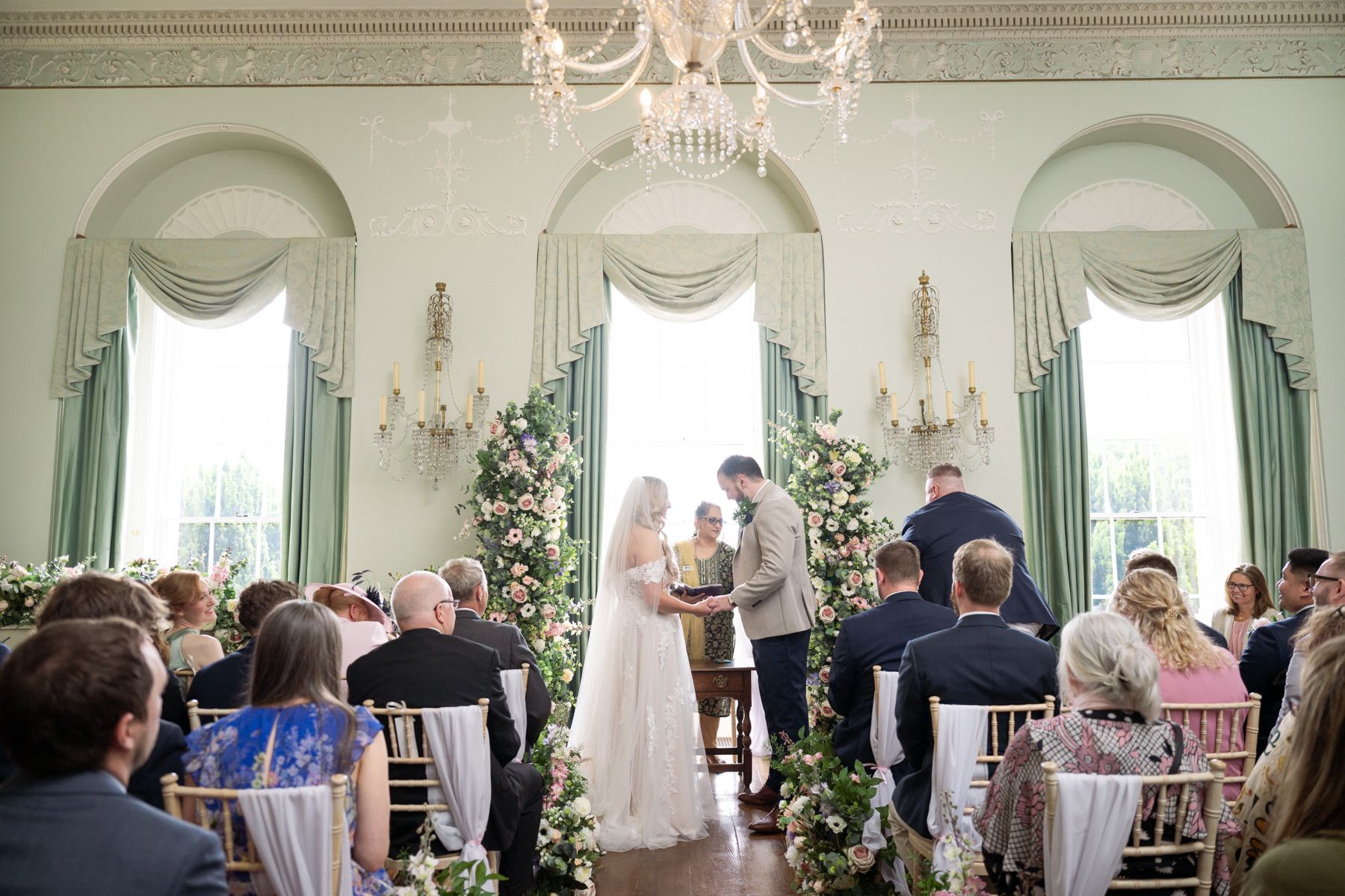 A couple exchange vows during their indoor wedding ceremony.