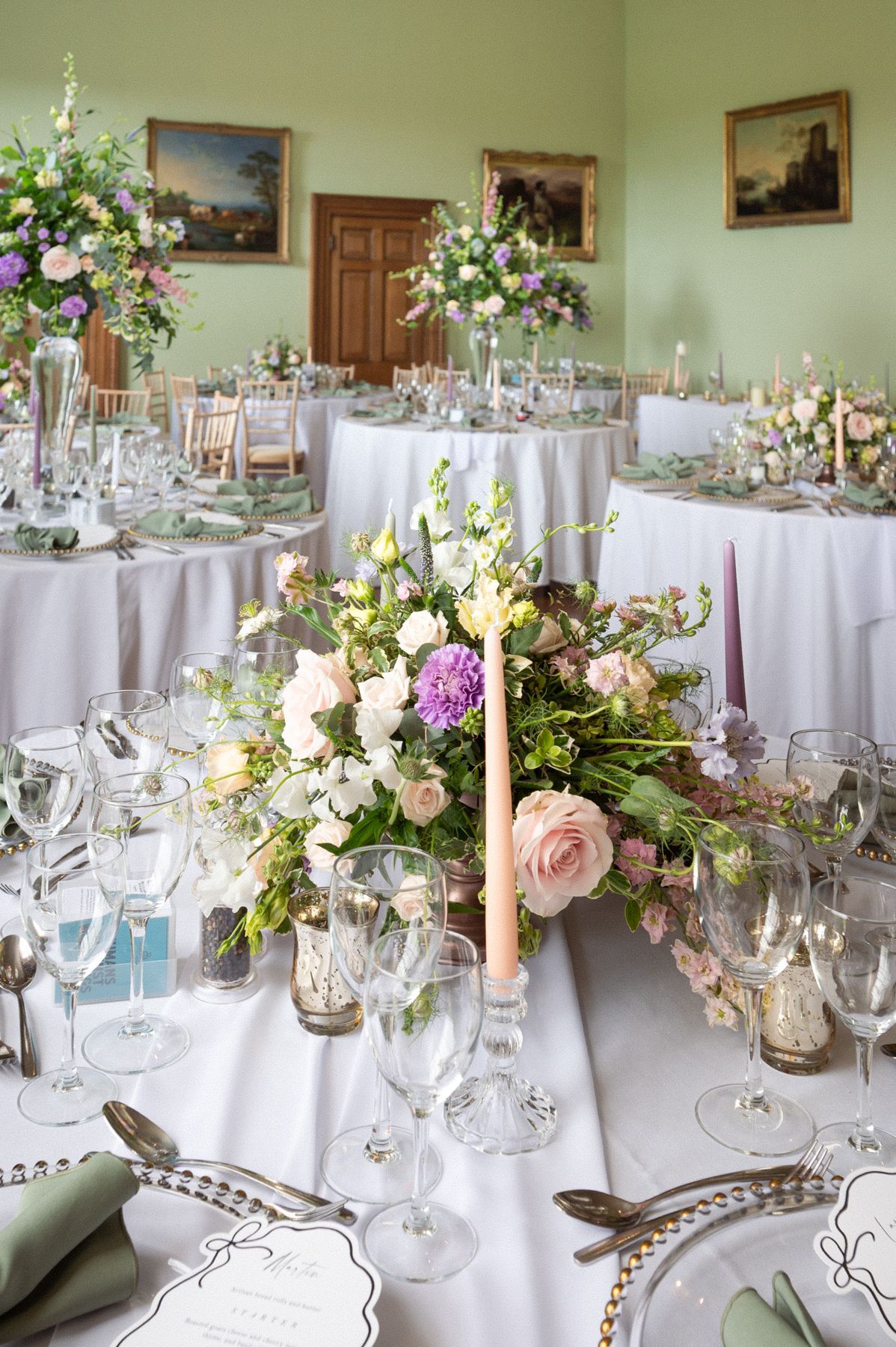 Dining tables decorated with flowers at Kelmarsh Hall.