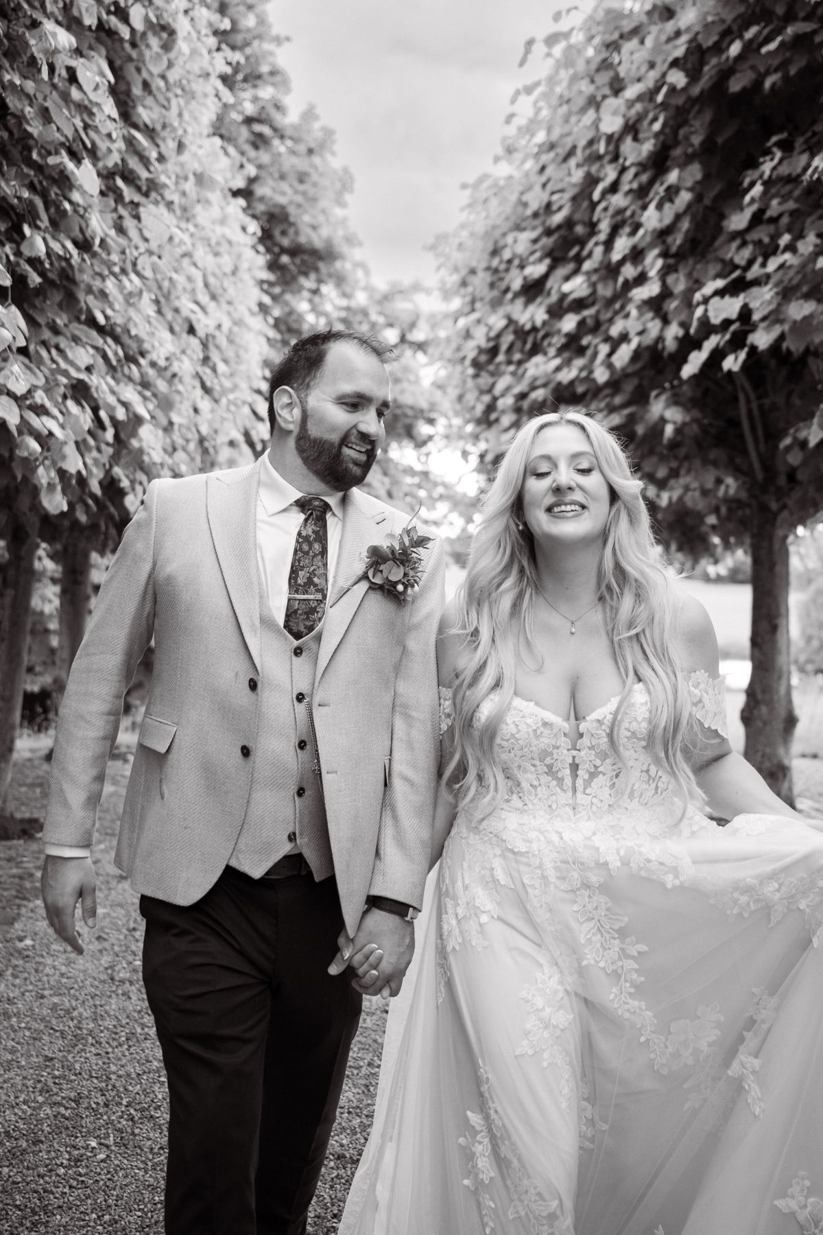 A bride and groom laugh during a wedding photography session.
