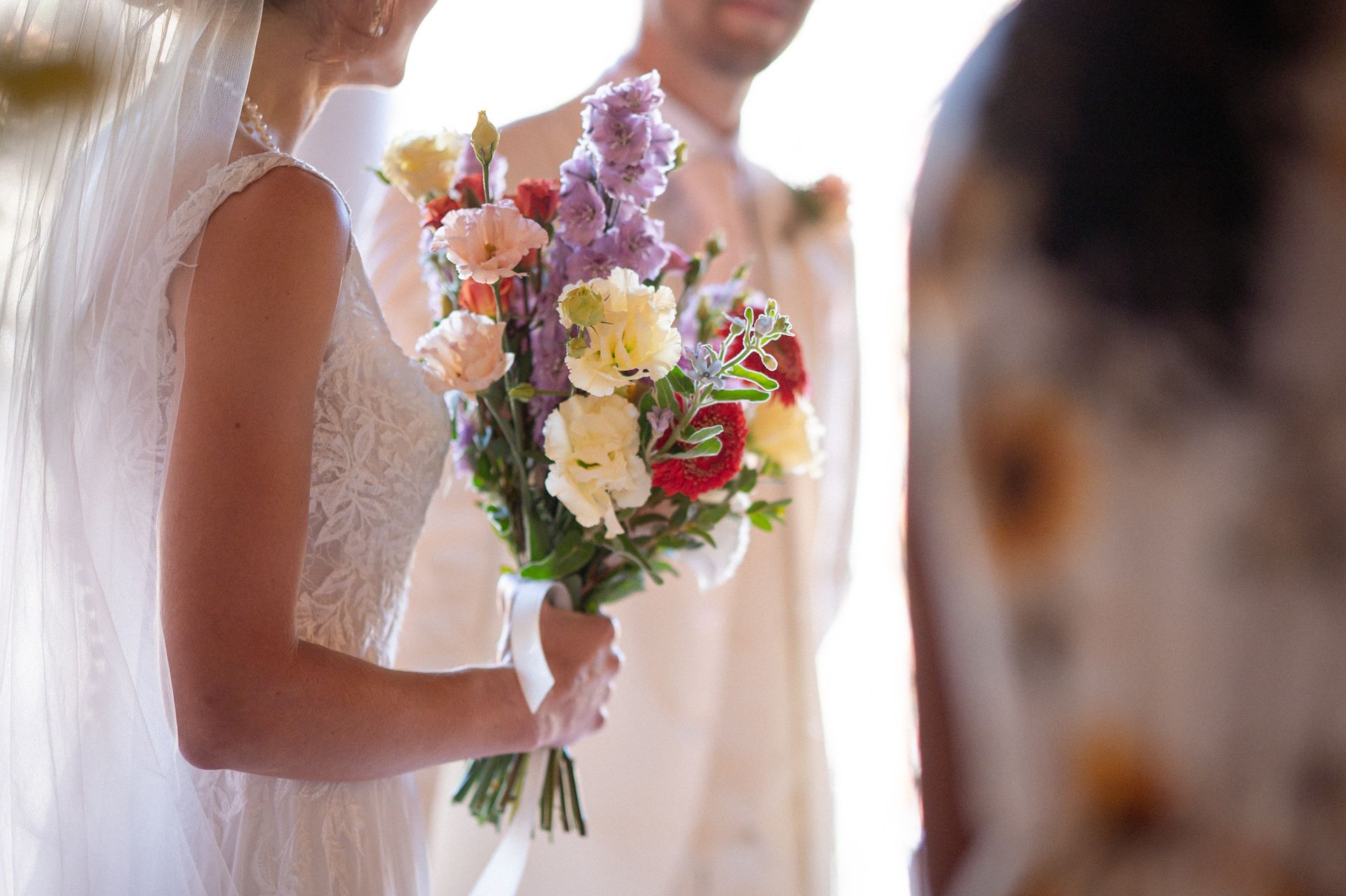 Le bouquet de mariée aux couleurs estivales de la Provence : crème, violet et rouge foncé.