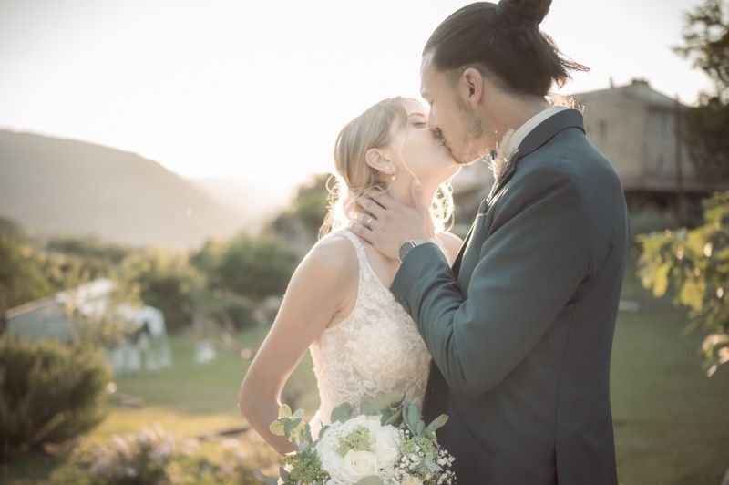 A bride and groom kiss after their wedding