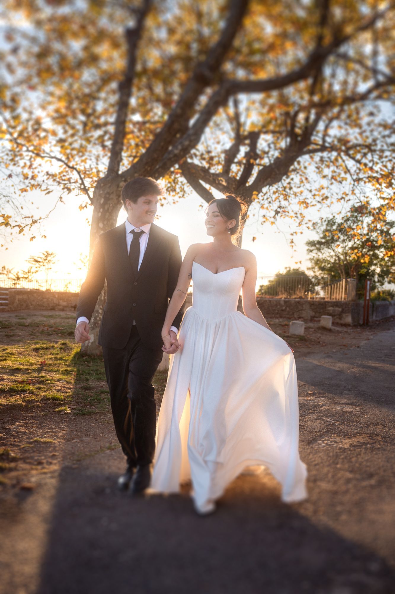 A candid image of a couple smiling and laughing on an autumn photoshoot after their elopement in the South of France.