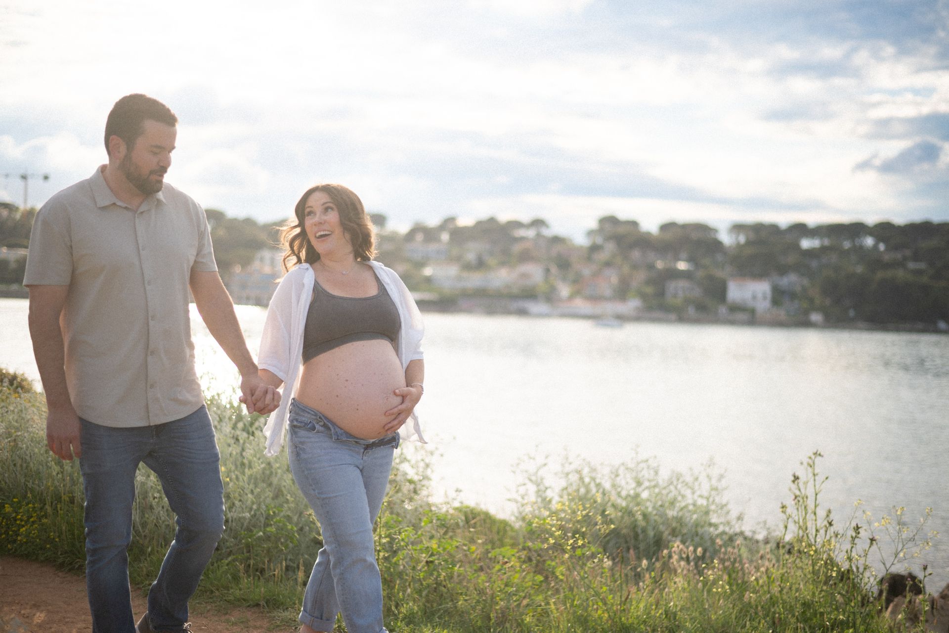a couple walking near the beach during a maternity photoshoot