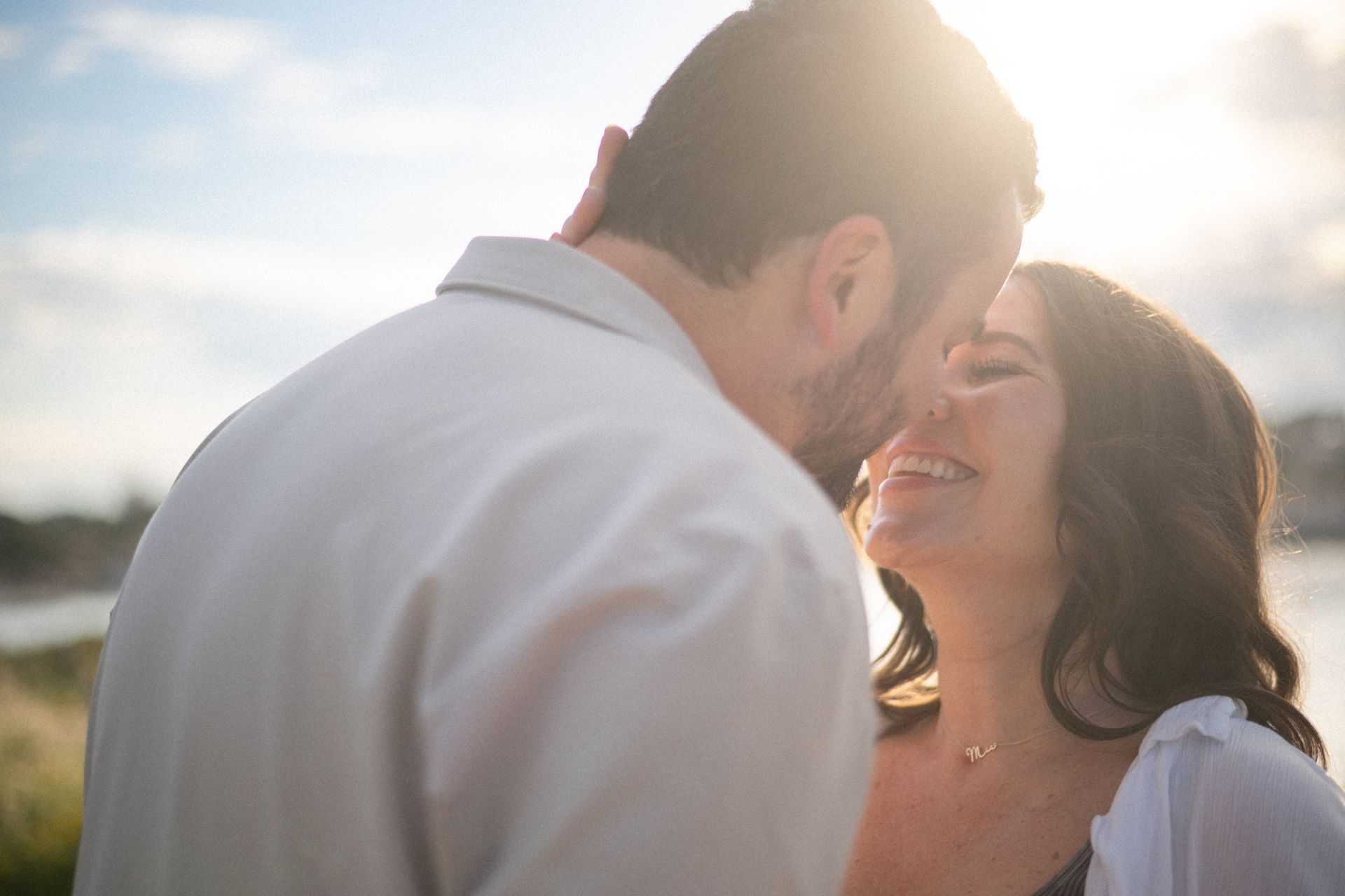 A couple kiss during a romantic moment during golden hour