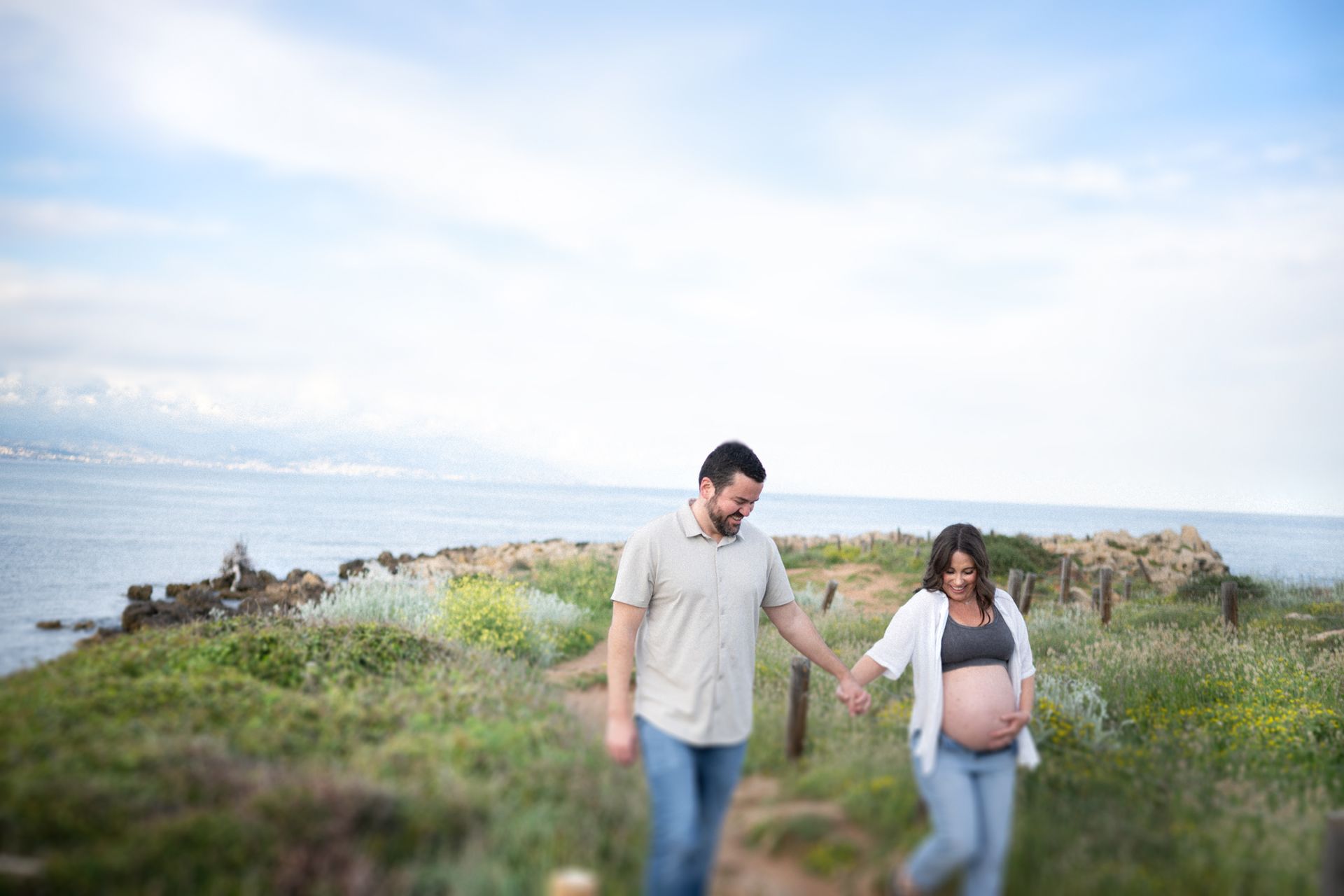 A pregnant lady walks with her partner during a maternity photography session near Nice, France.