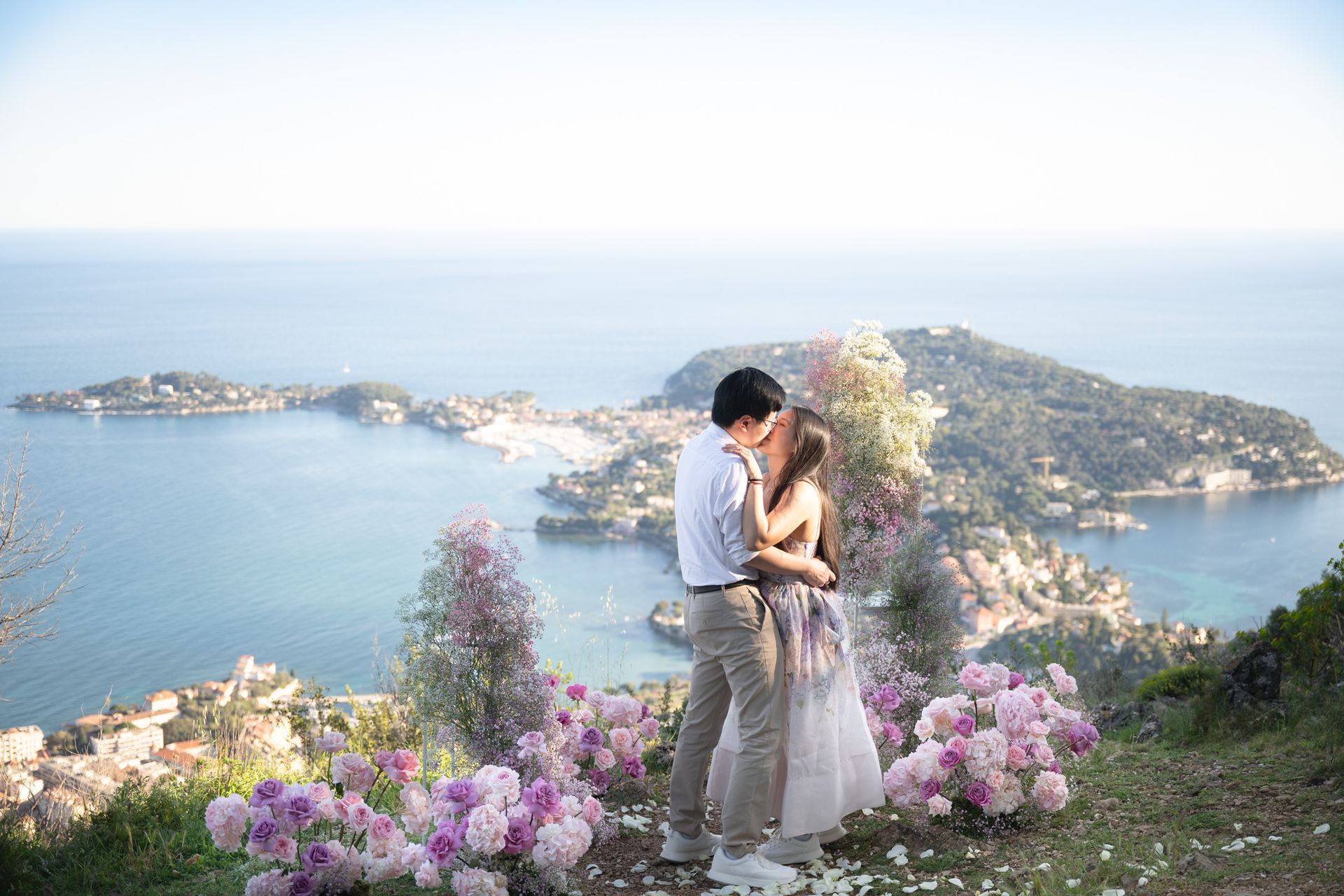 A couple hug after getting engaged after a surprise proposal.