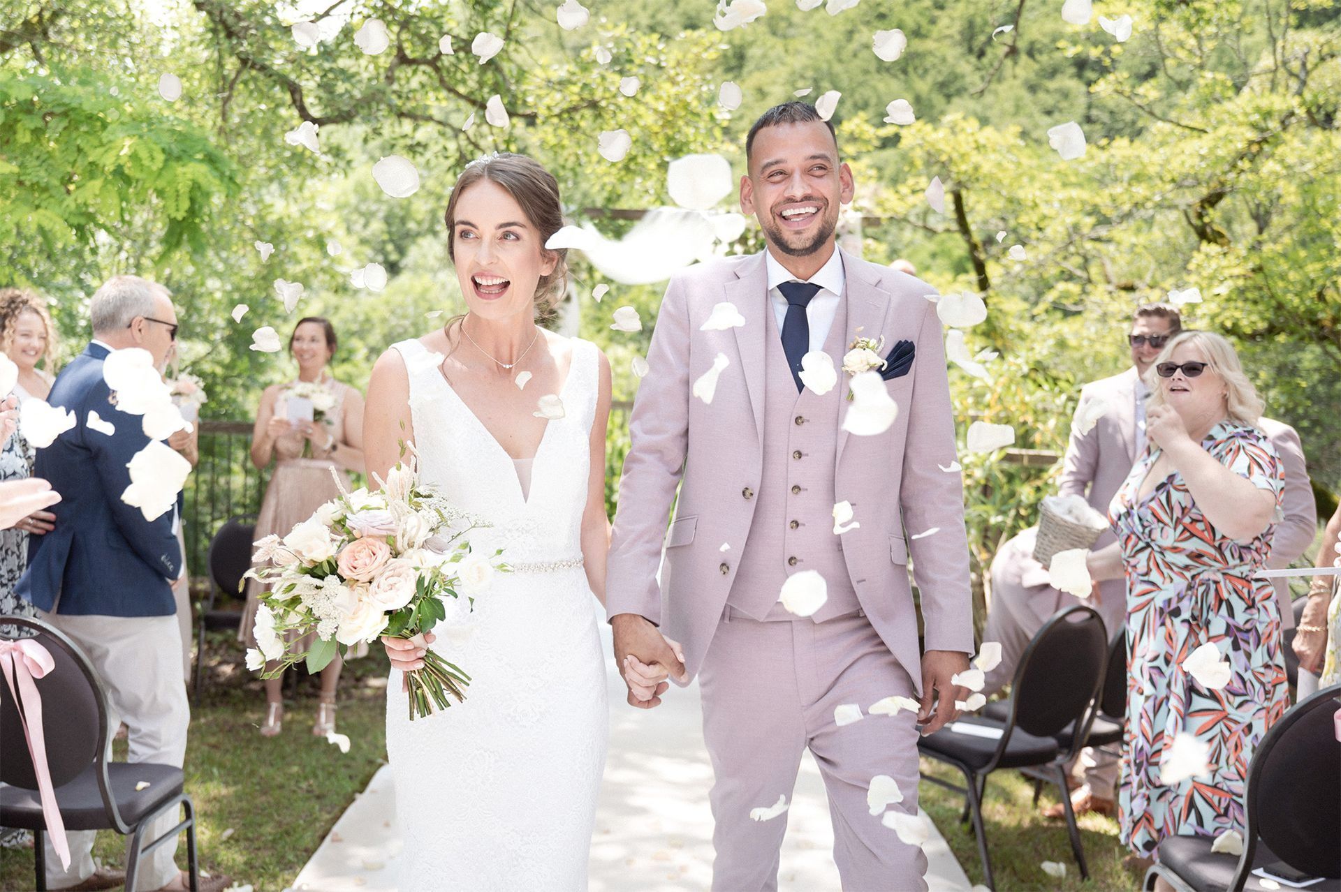 Newly weds smile as they are showered with confetti at their wedding in the South of France