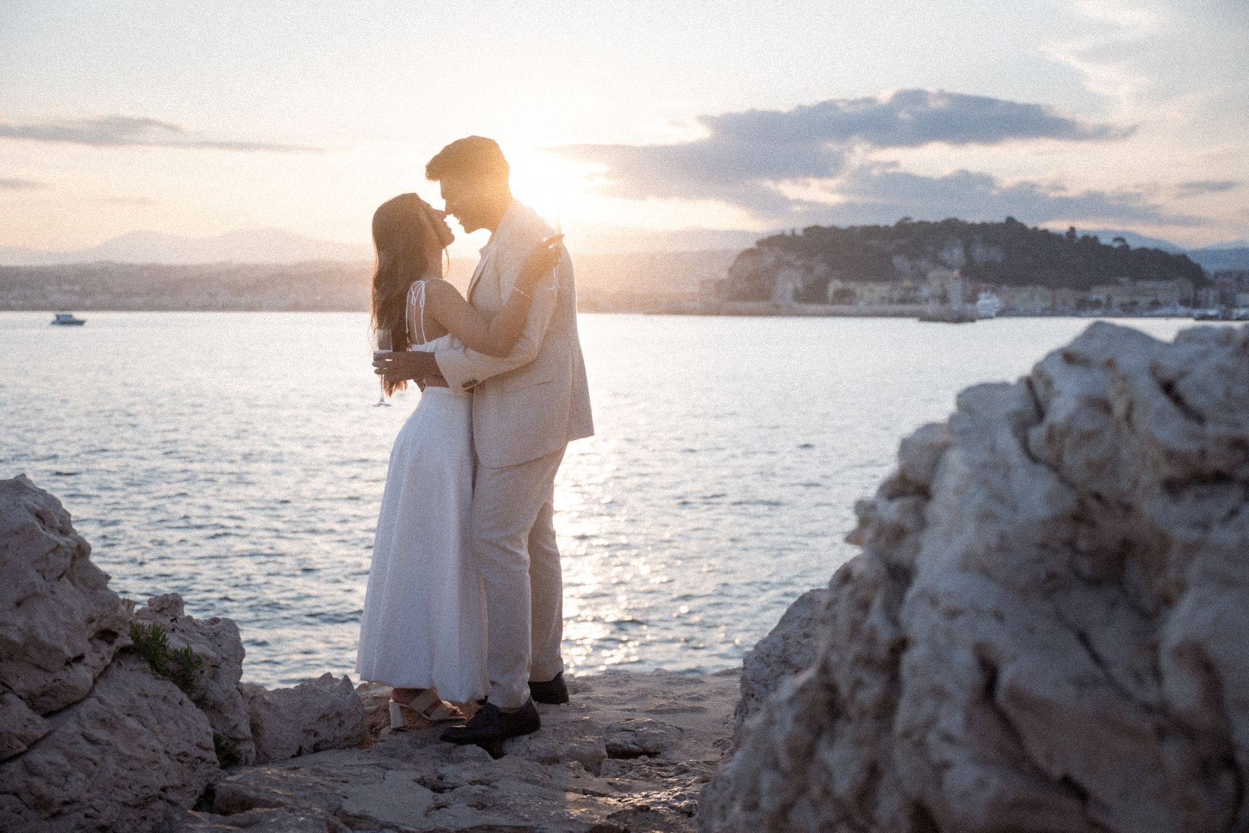 A couple before a sunset with Nice, France, in the background.