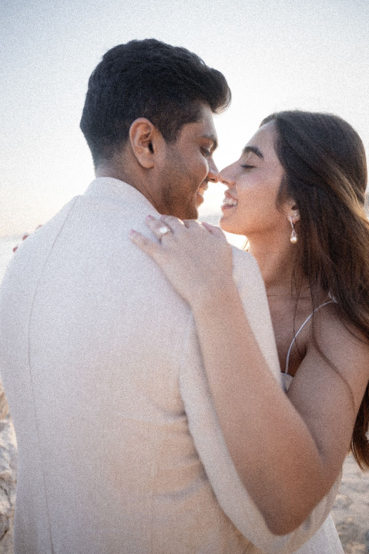A couple kiss during a professional photography session.