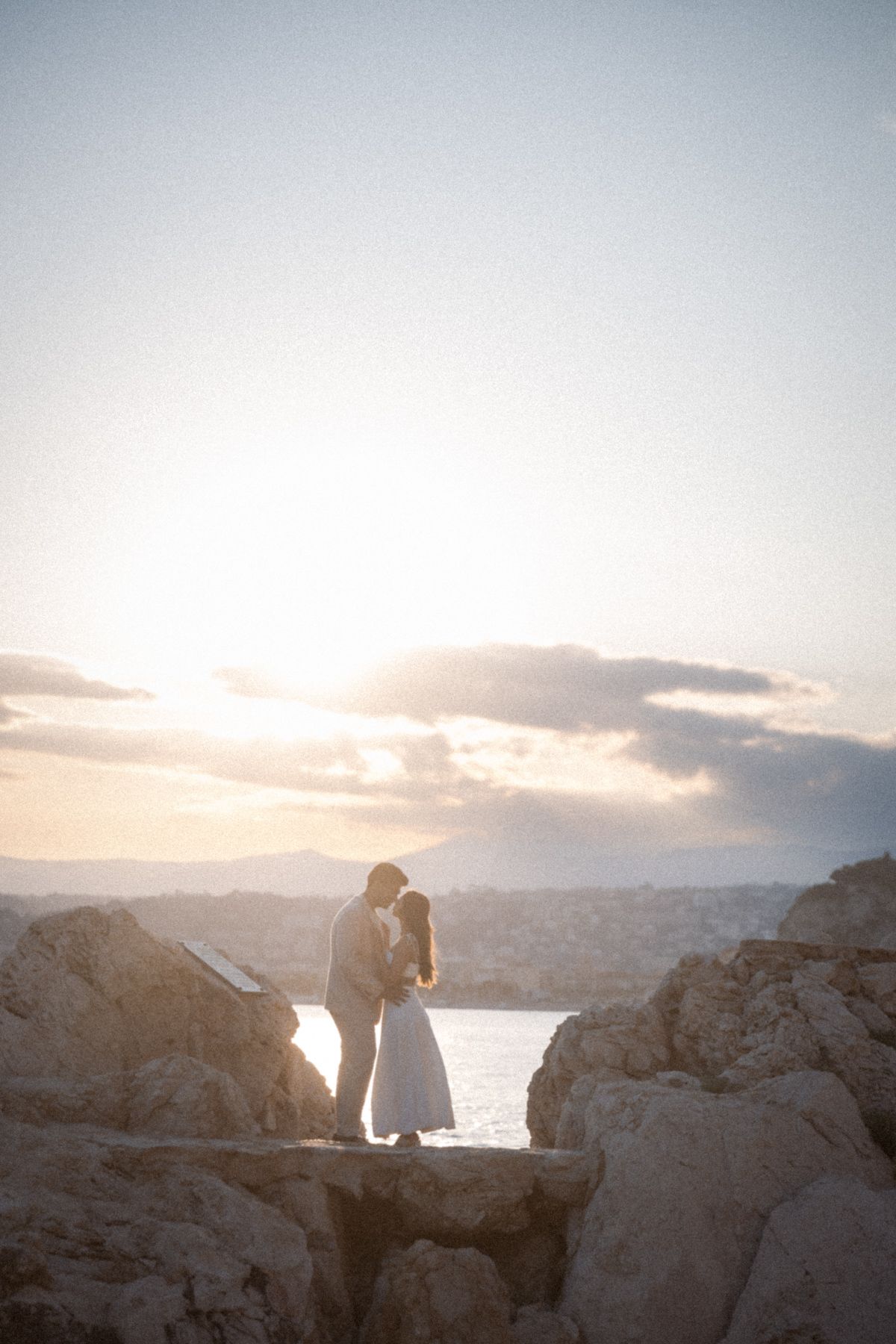 A dramatic wide angle shot of a couple at sunset on the French Riviera.