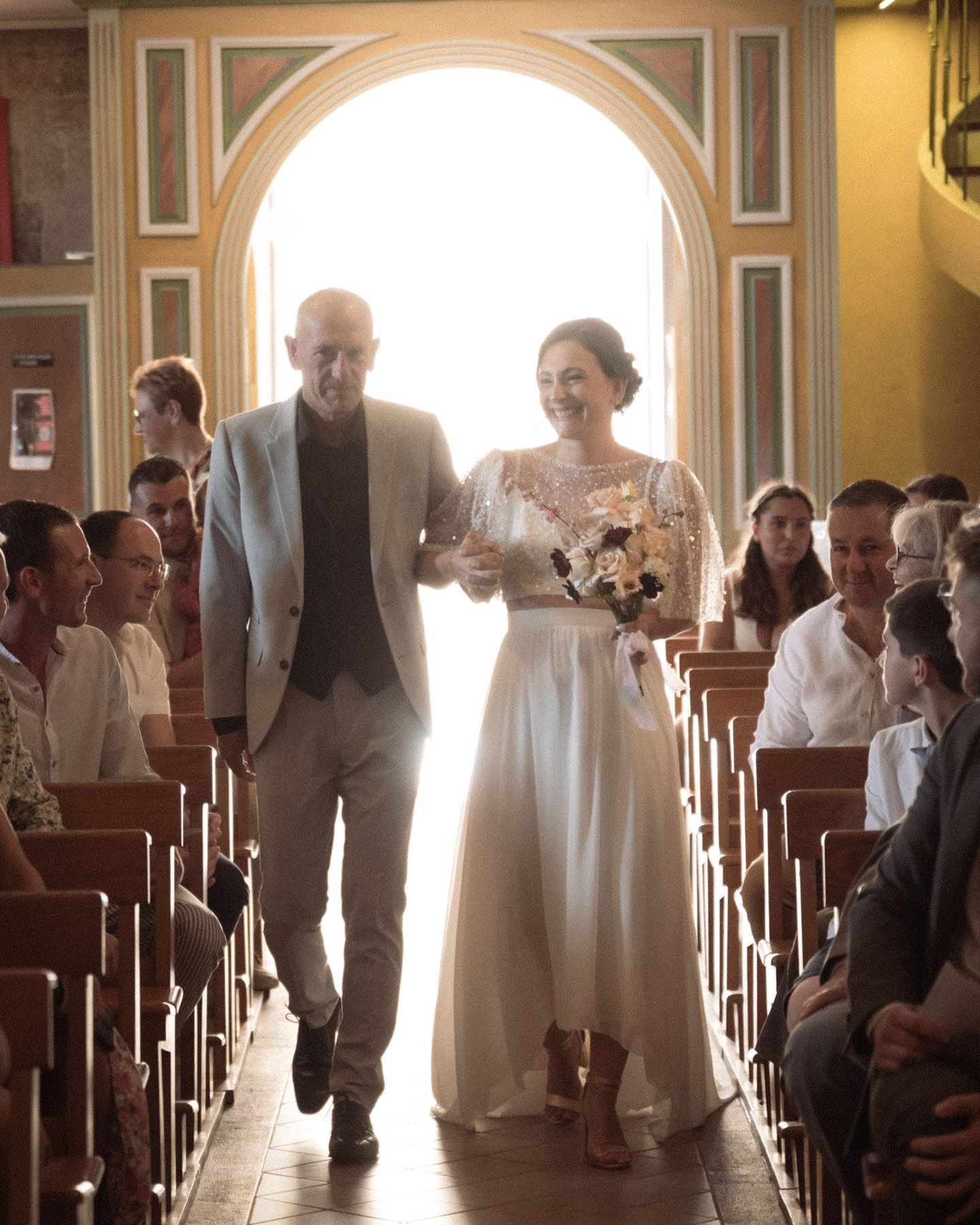 the bride walks down the church aisle