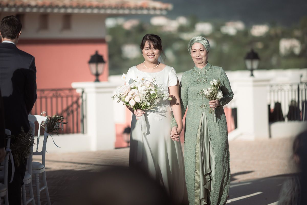 The bride and her mother enter the ceremony at Chateau Cremat
