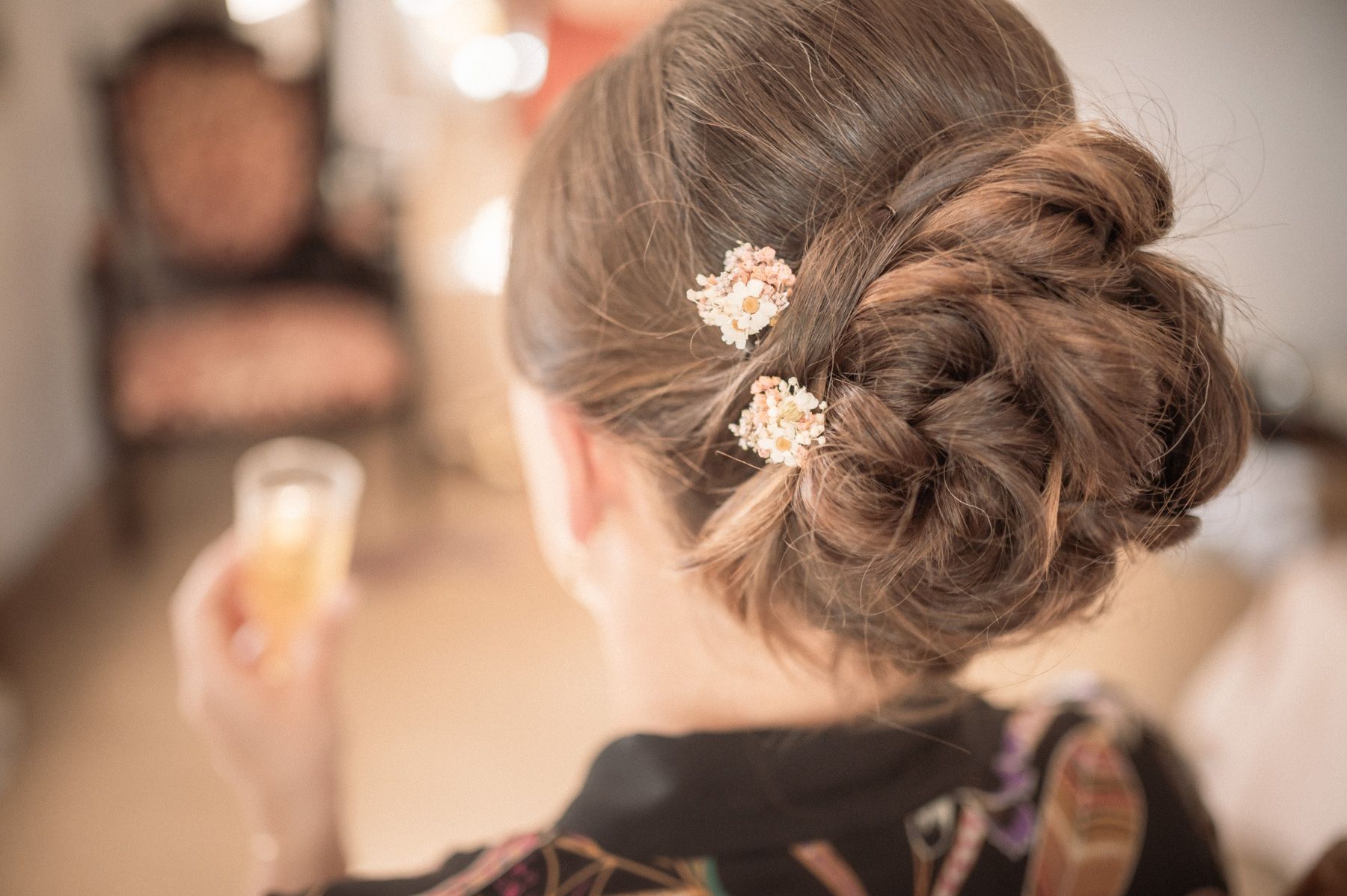 bridal hair tied up in a bun and decorated with flowers
