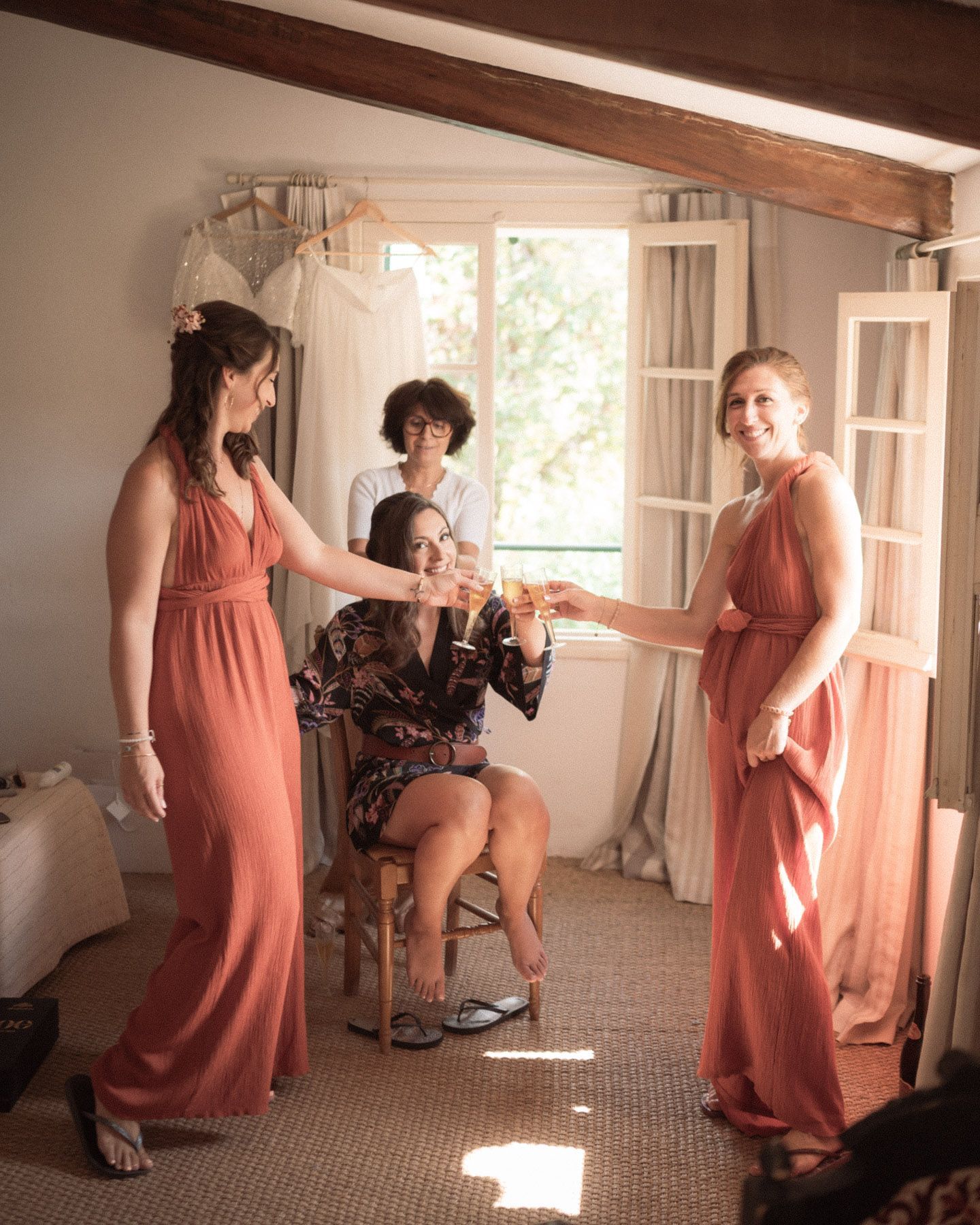 bride smiles with bridesmaids during preparations