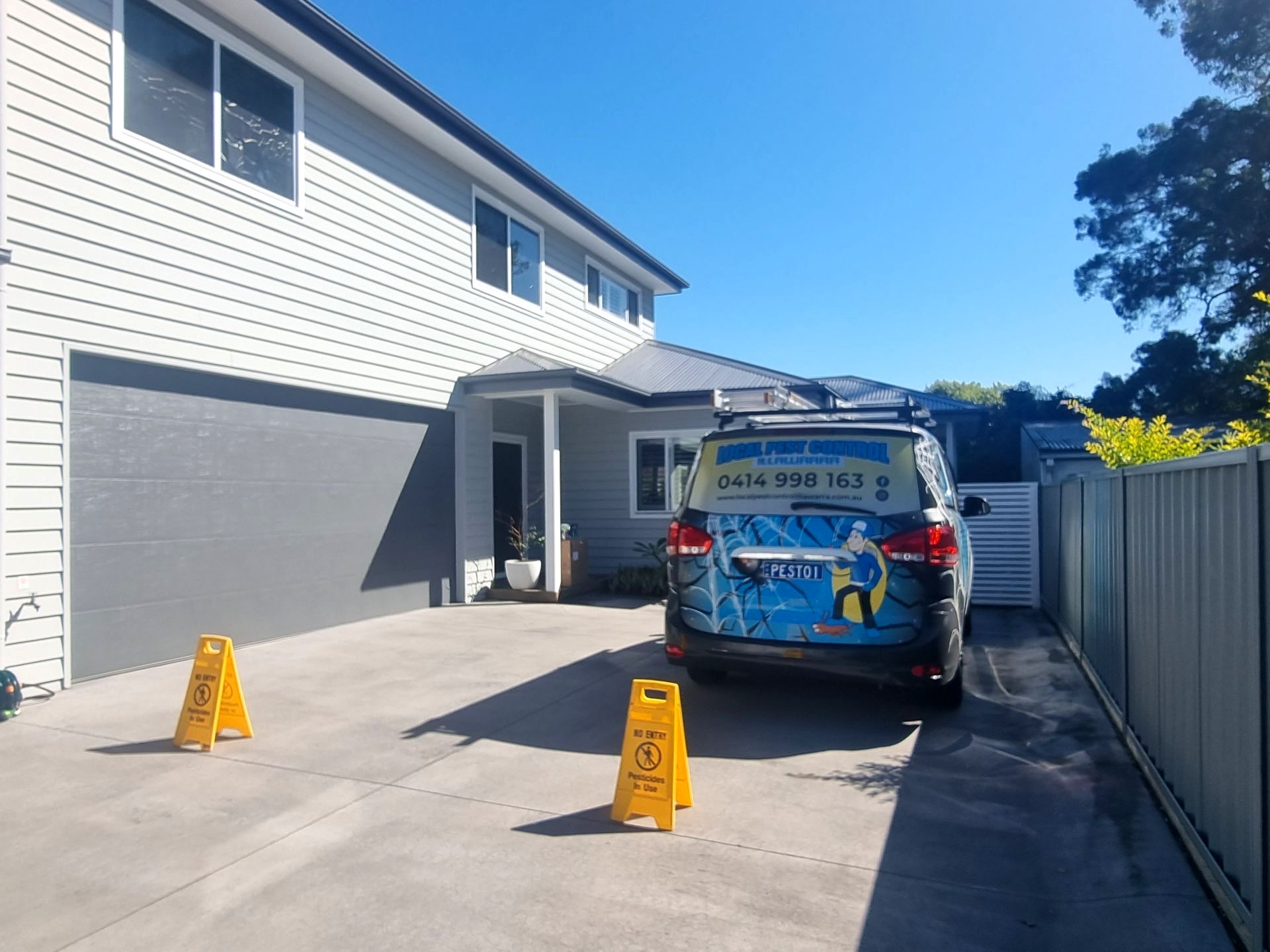 A Blue Van Is Parked In Front Of A House — Local Pest Control Illawarra in Horsley, NSW