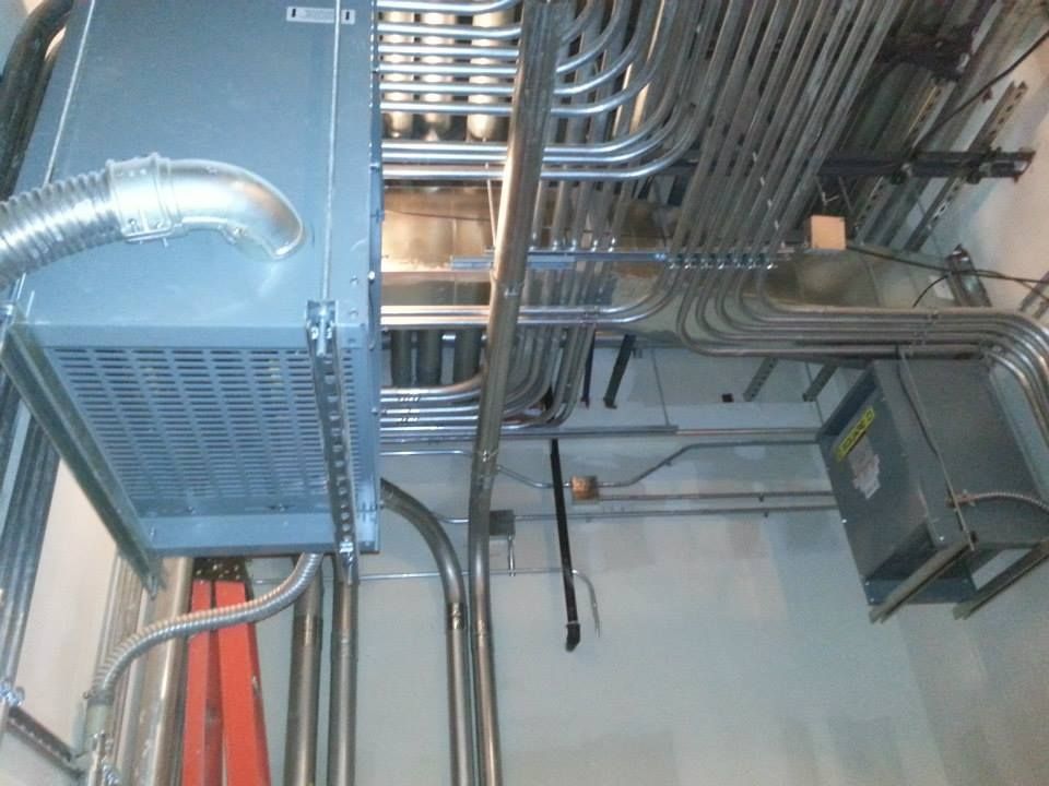 Electrical panels and conduit wiring in a utility room ceiling area