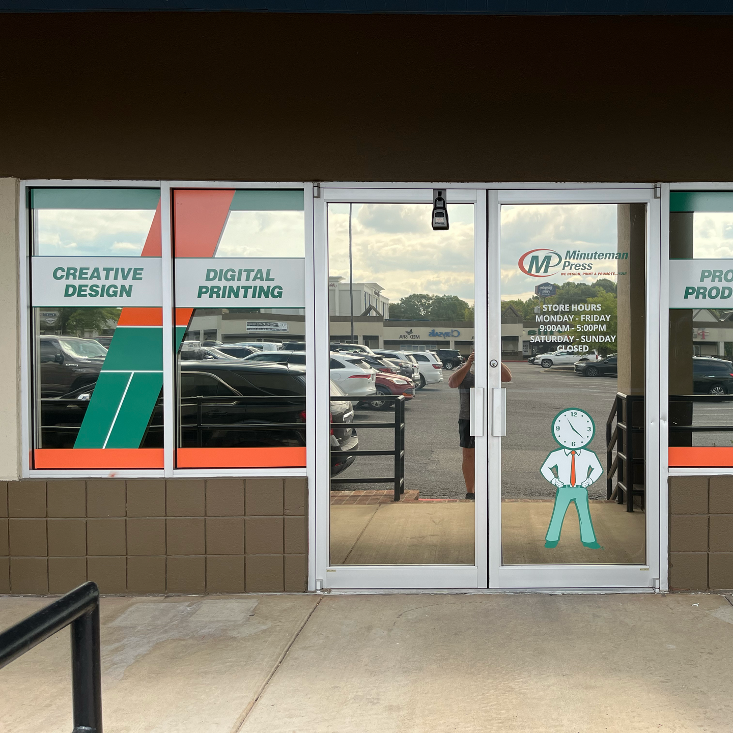 Exterior of a print shop with glass doors, featuring signage | sign printer near me