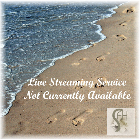 Beach shoreline with footprints and text: “Live Streaming Service Not Currently Available”