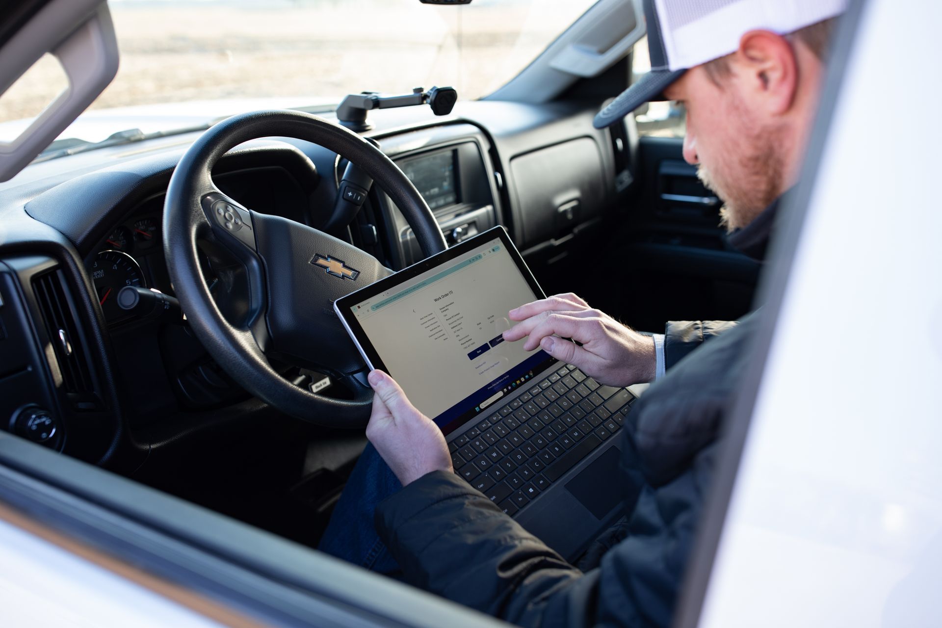 Spray drone operator using AcreConnect software on a tablet device.