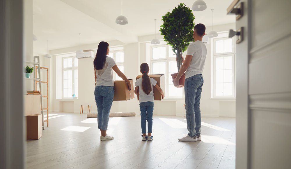 Happy Family Moving In With Their Belongings — Mortgage Brokers In Mundingburra, QLD