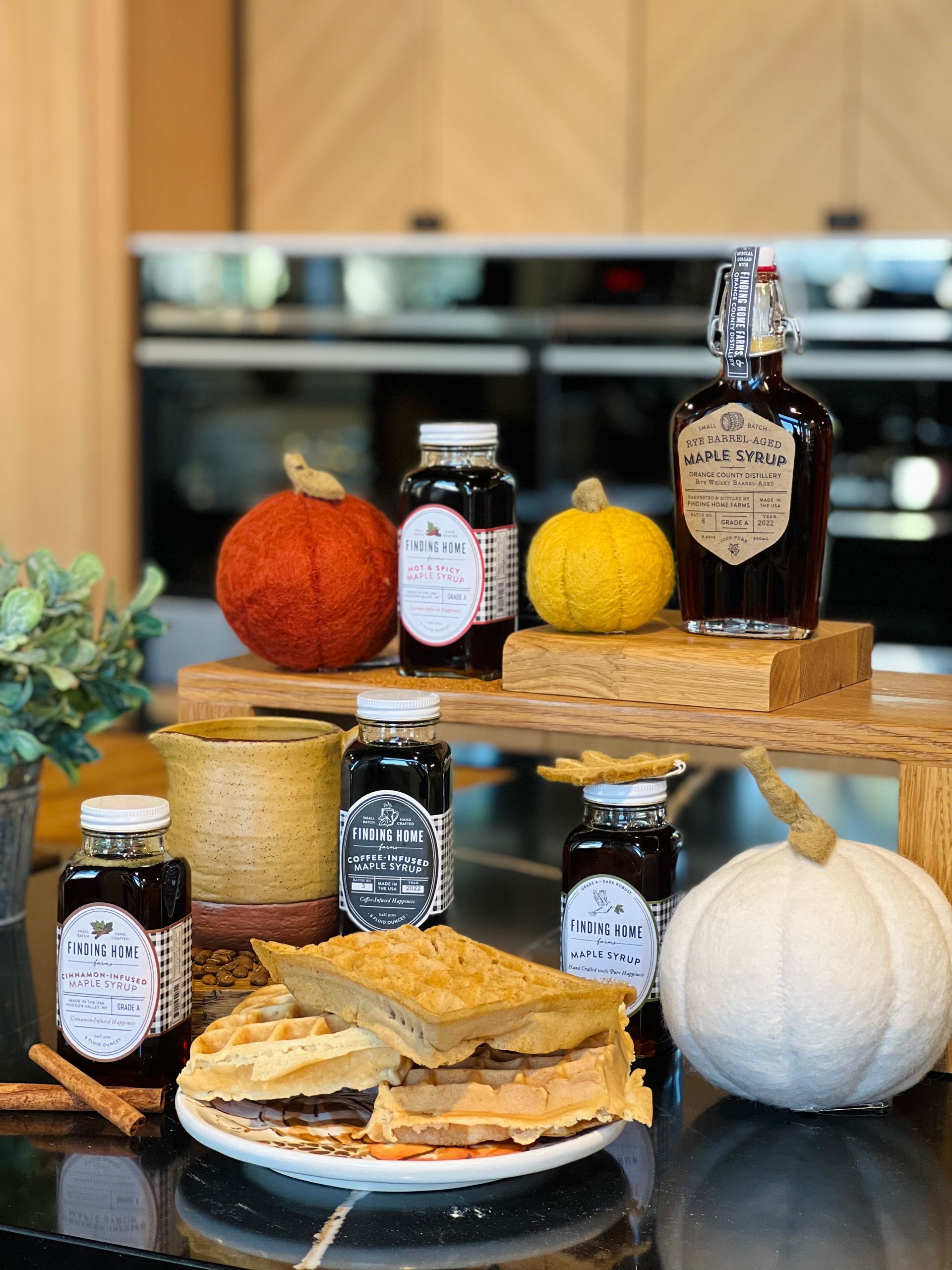 a pie is sitting on a table next to jars of jam and pumpkins .