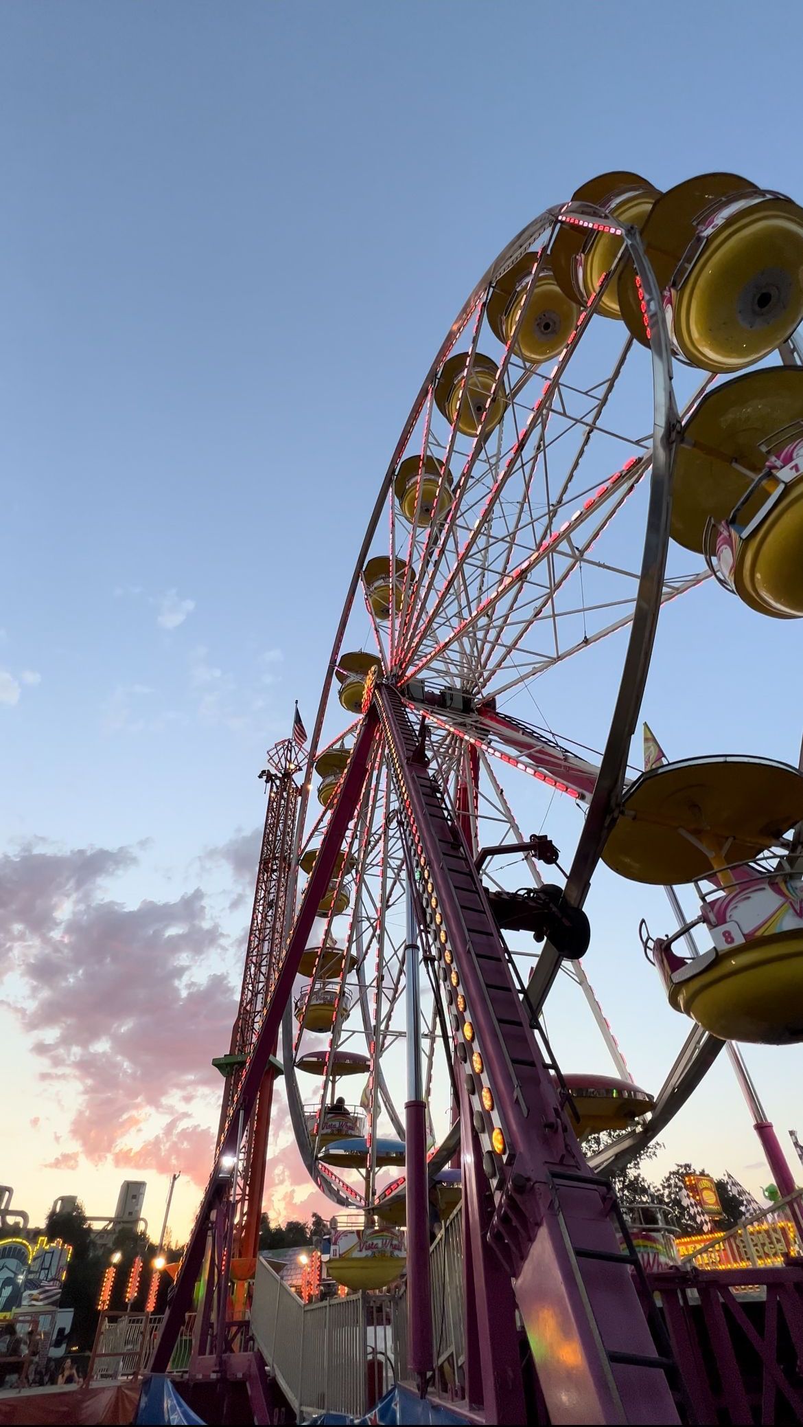 a ferris wheel at a carnival with a blue sky in the background .