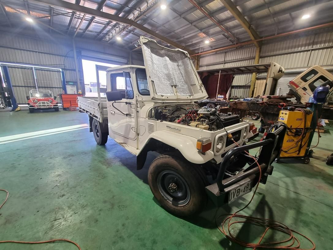 A White Truck Is Parked in A Garage with Its Hood Open — D.J. Auto Electrics NT in Berrimah, NT