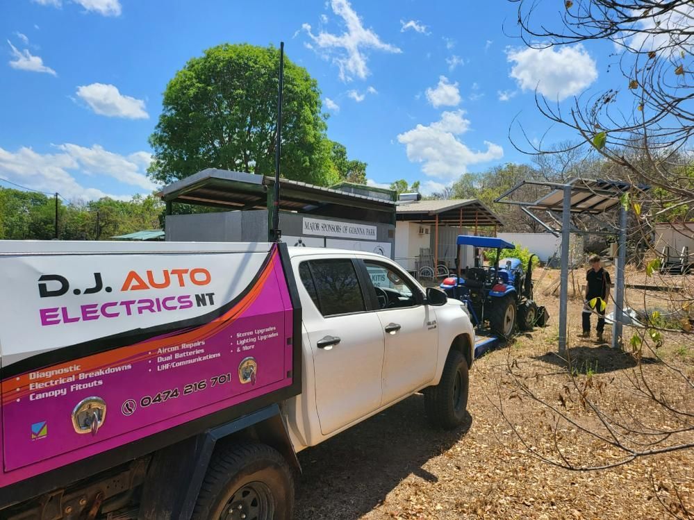 A White Truck Is Parked in A Field Next to A Tractor — D.J. Auto Electrics NT in Berrimah, NT