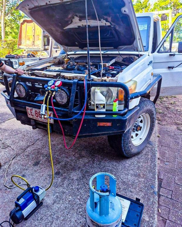 A Man Is Working on A White Truck with The Hood Up — D.J. Auto Electrics NT in Berrimah, NT